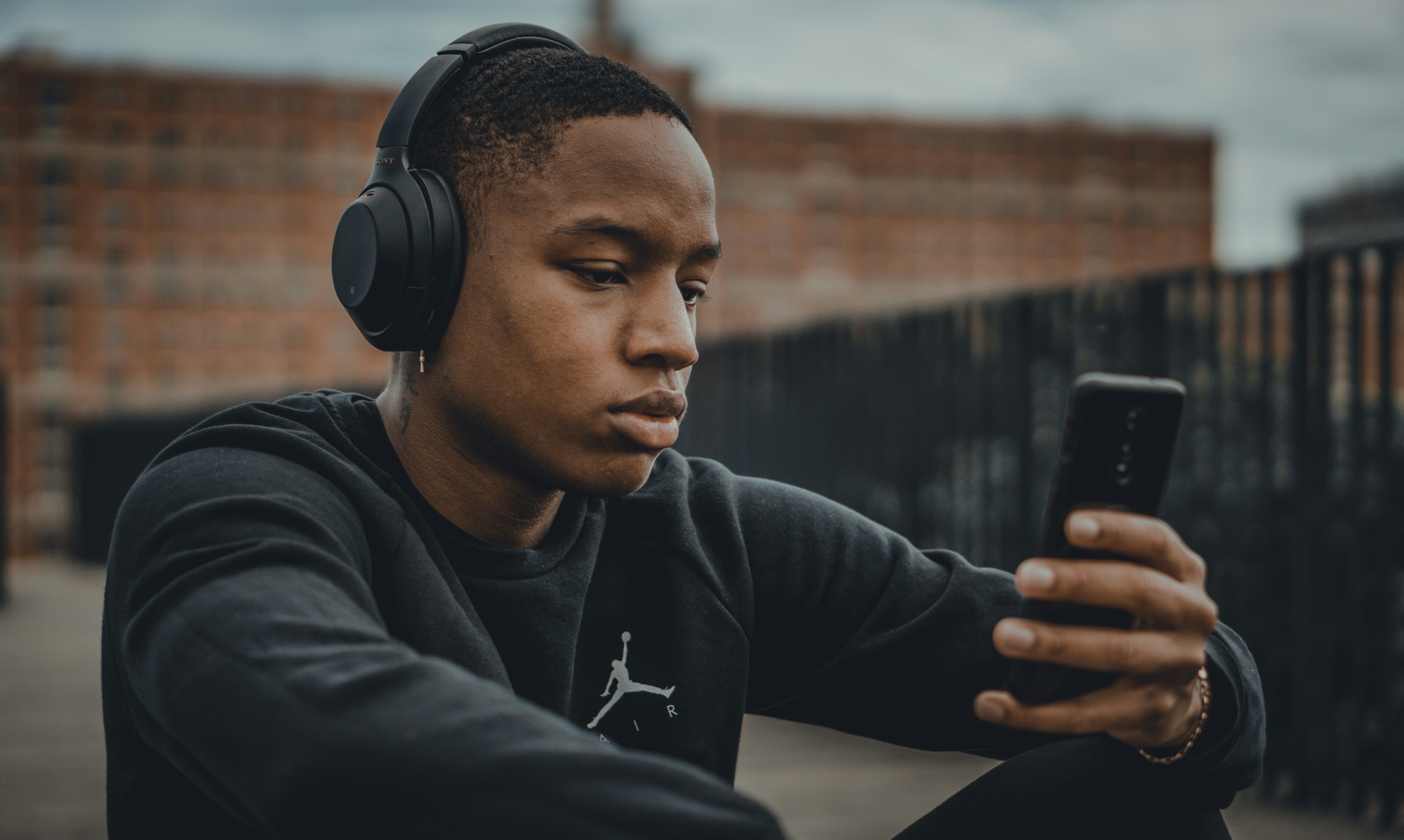 Un niño infeliz usando su teléfono | Fuente: Unsplash