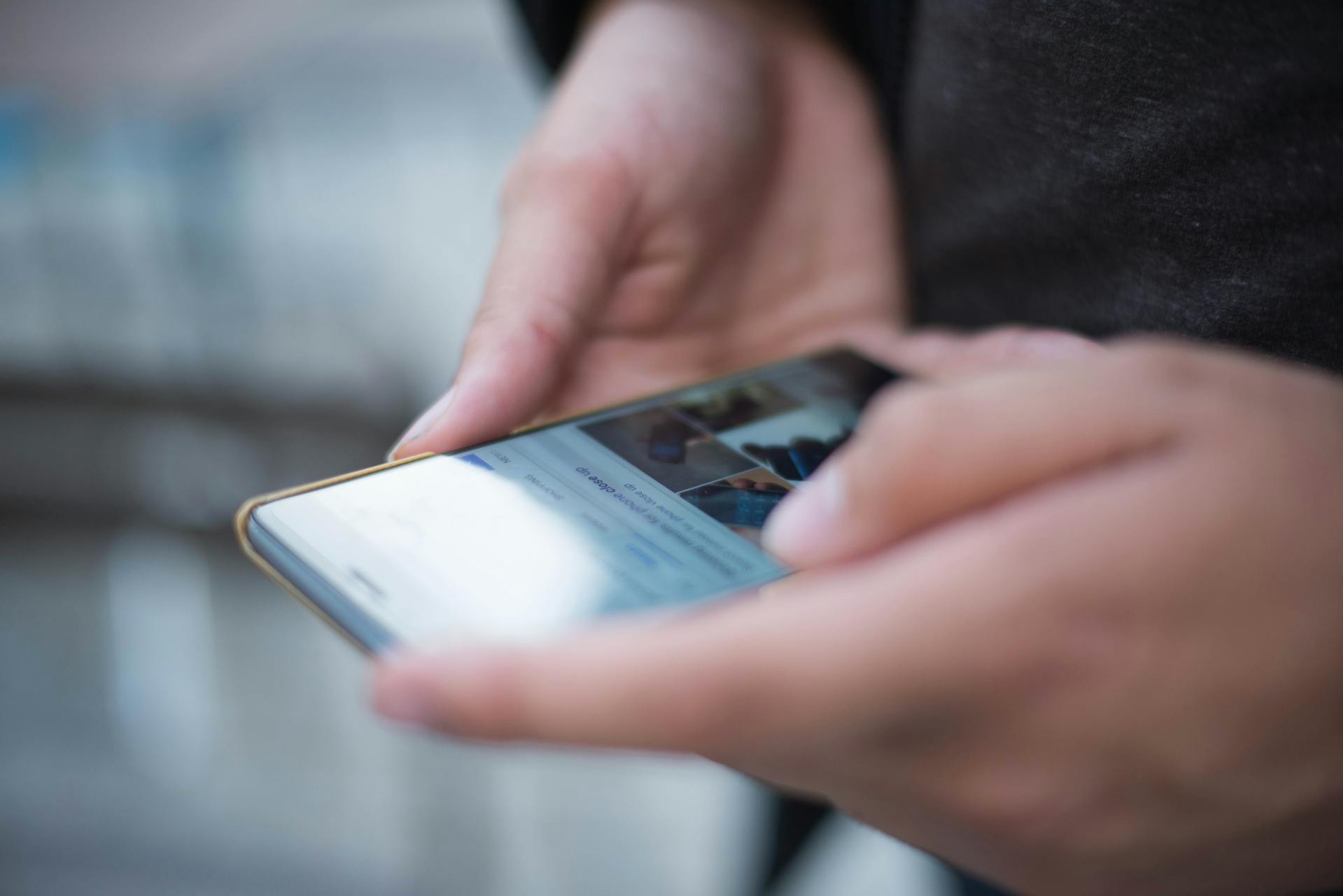 Un hombre sujetando su teléfono | Fuente: Pexels