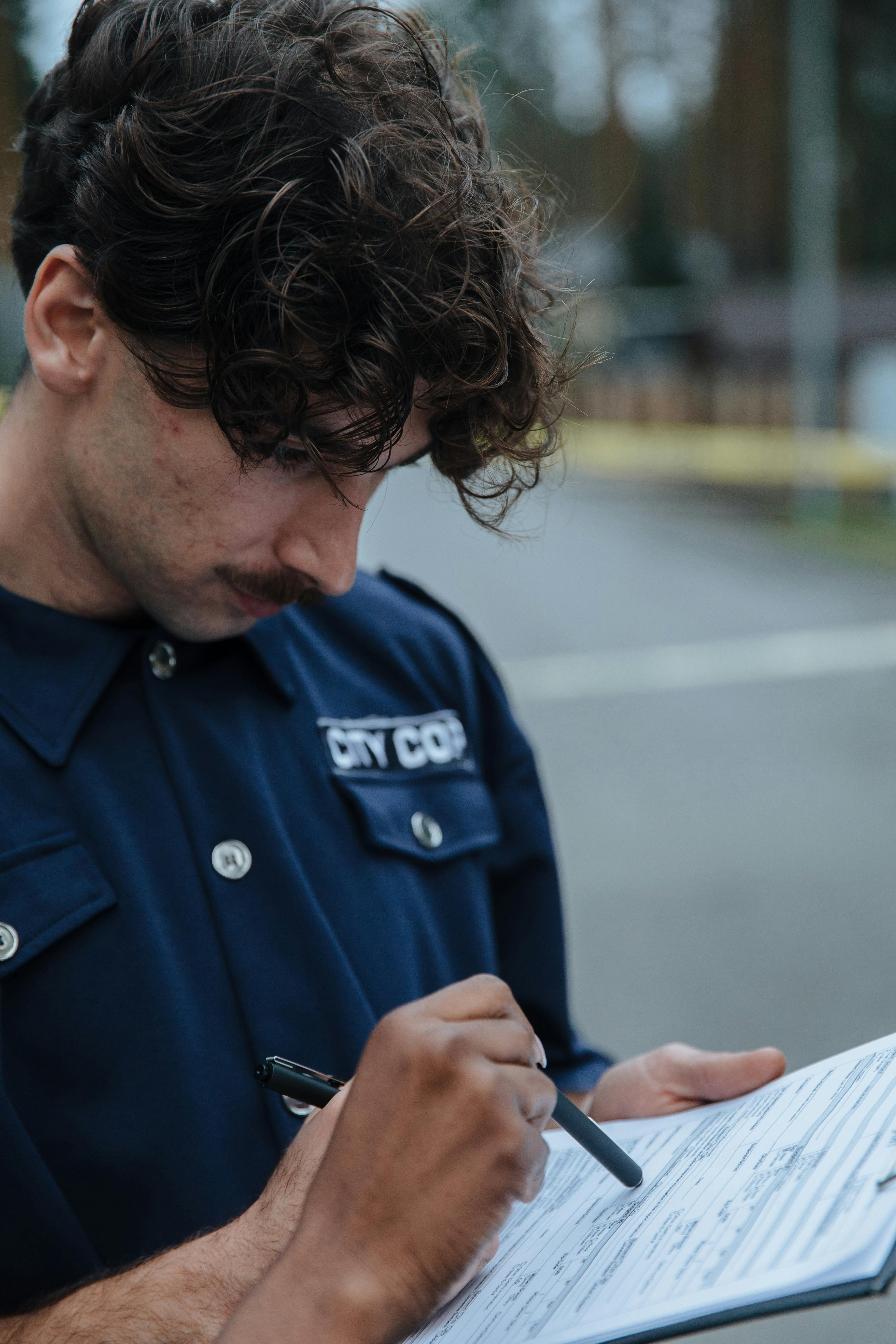 Un agente de policía mirando un documento | Fuente: Pexels