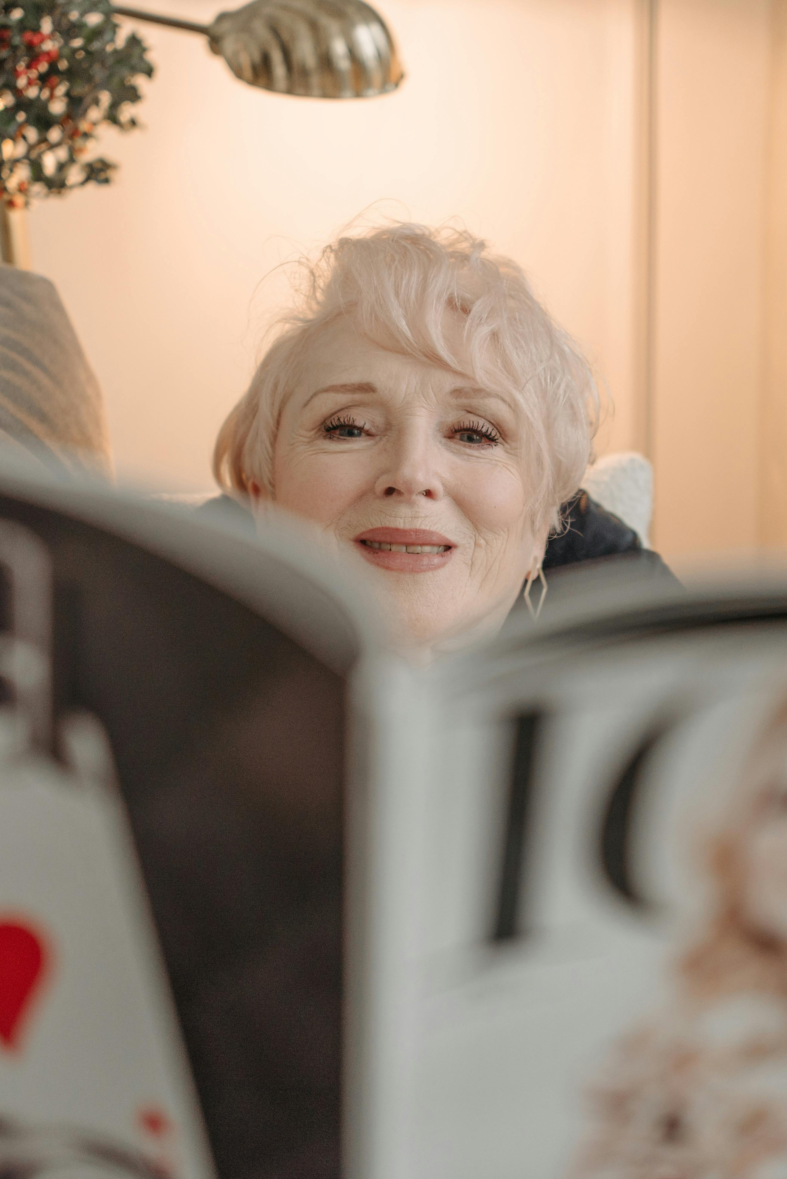 Una mujer feliz hojeando una revista | Fuente: Pexels