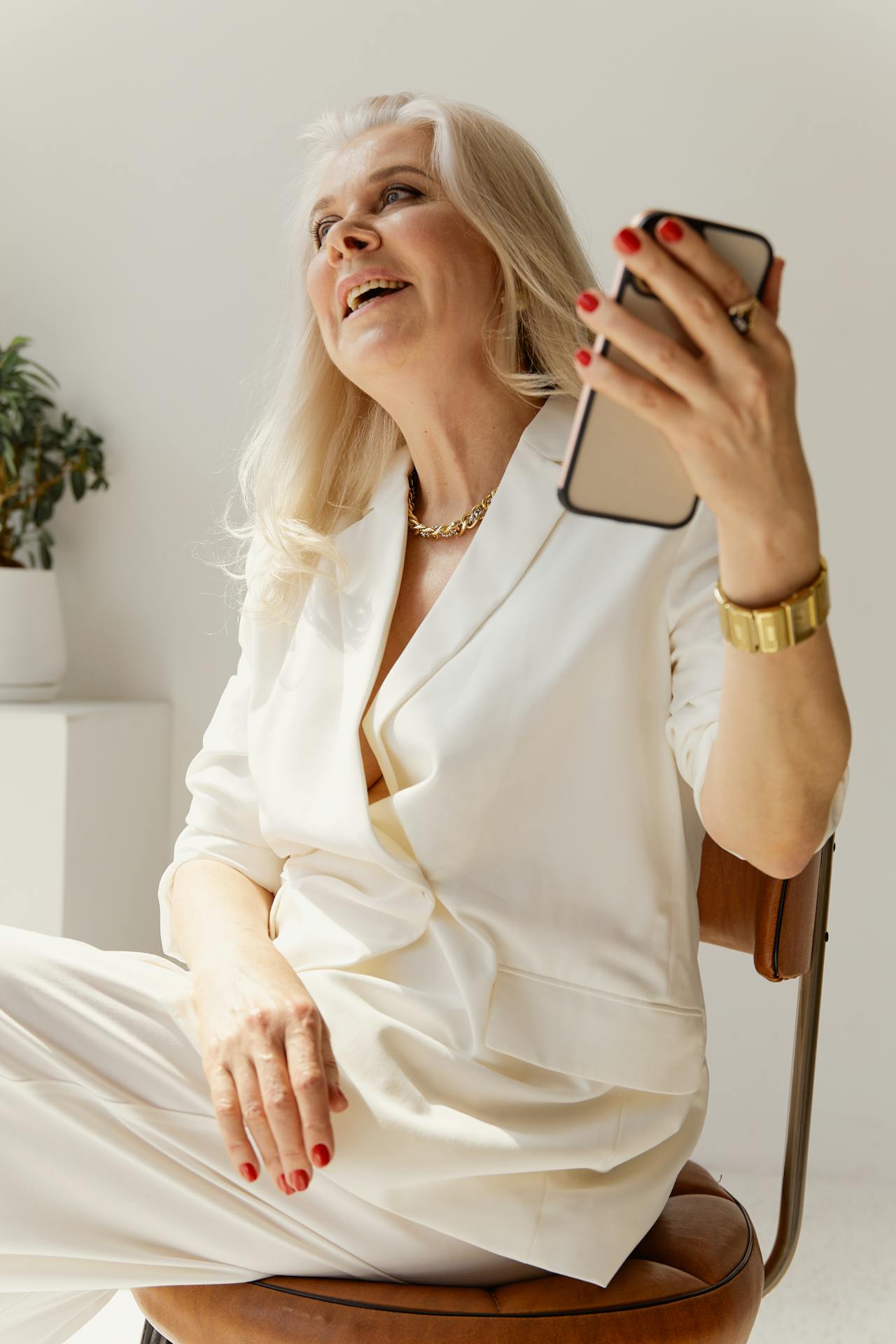 Una anciana sujetando su teléfono | Fuente: Pexels