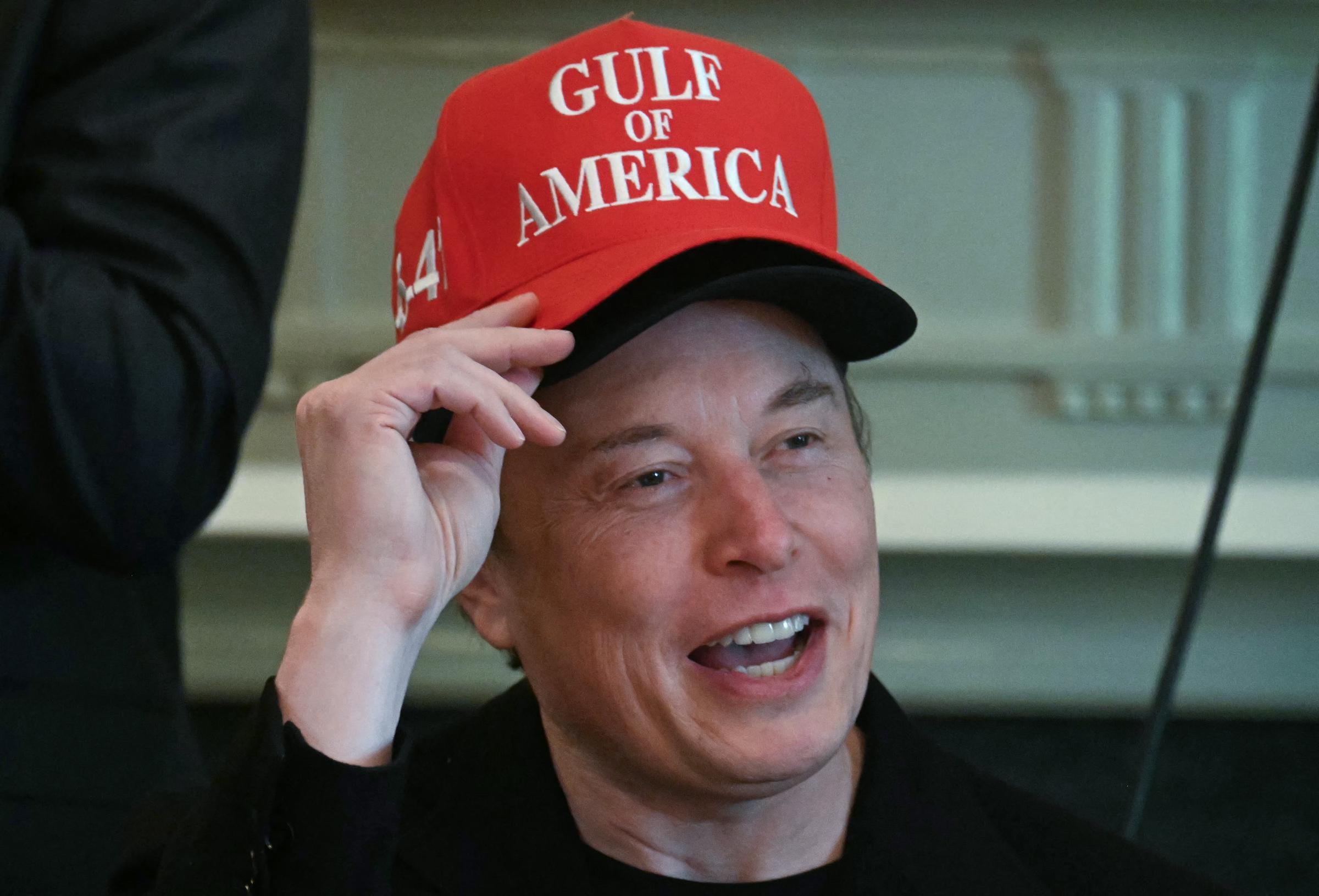 Elon Musk lleva dos sombreros mientras habla durante una reunión de gabinete | Fuente: Getty Images