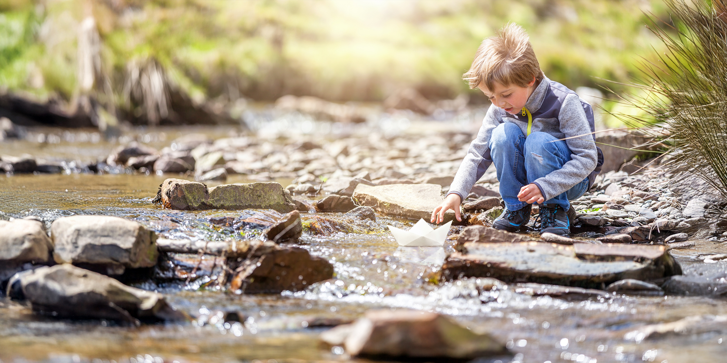 Un niño jugando en un arroyo | Fuente: Shutterstock