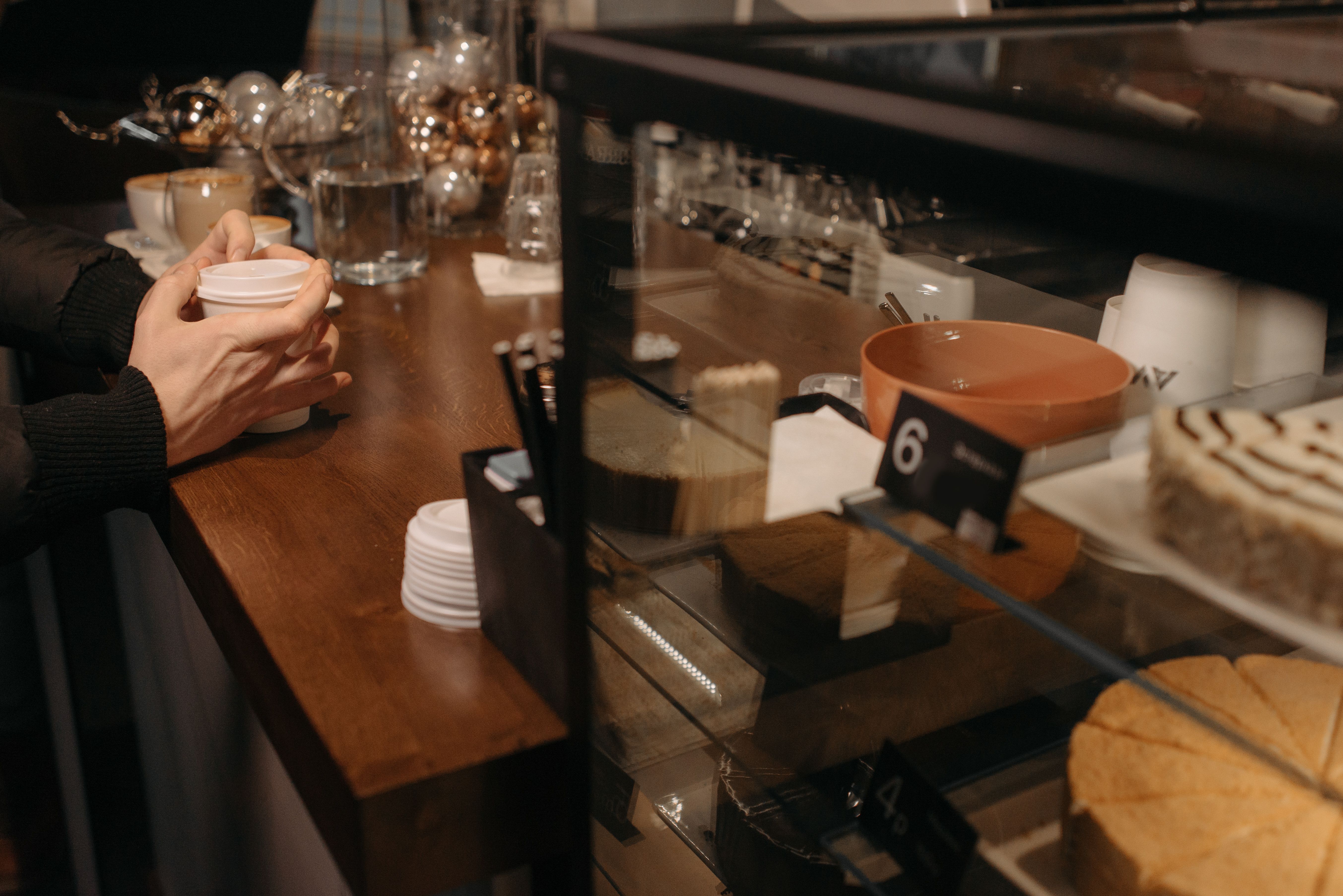 A person sitting at a restaurant table | Source: Pexels