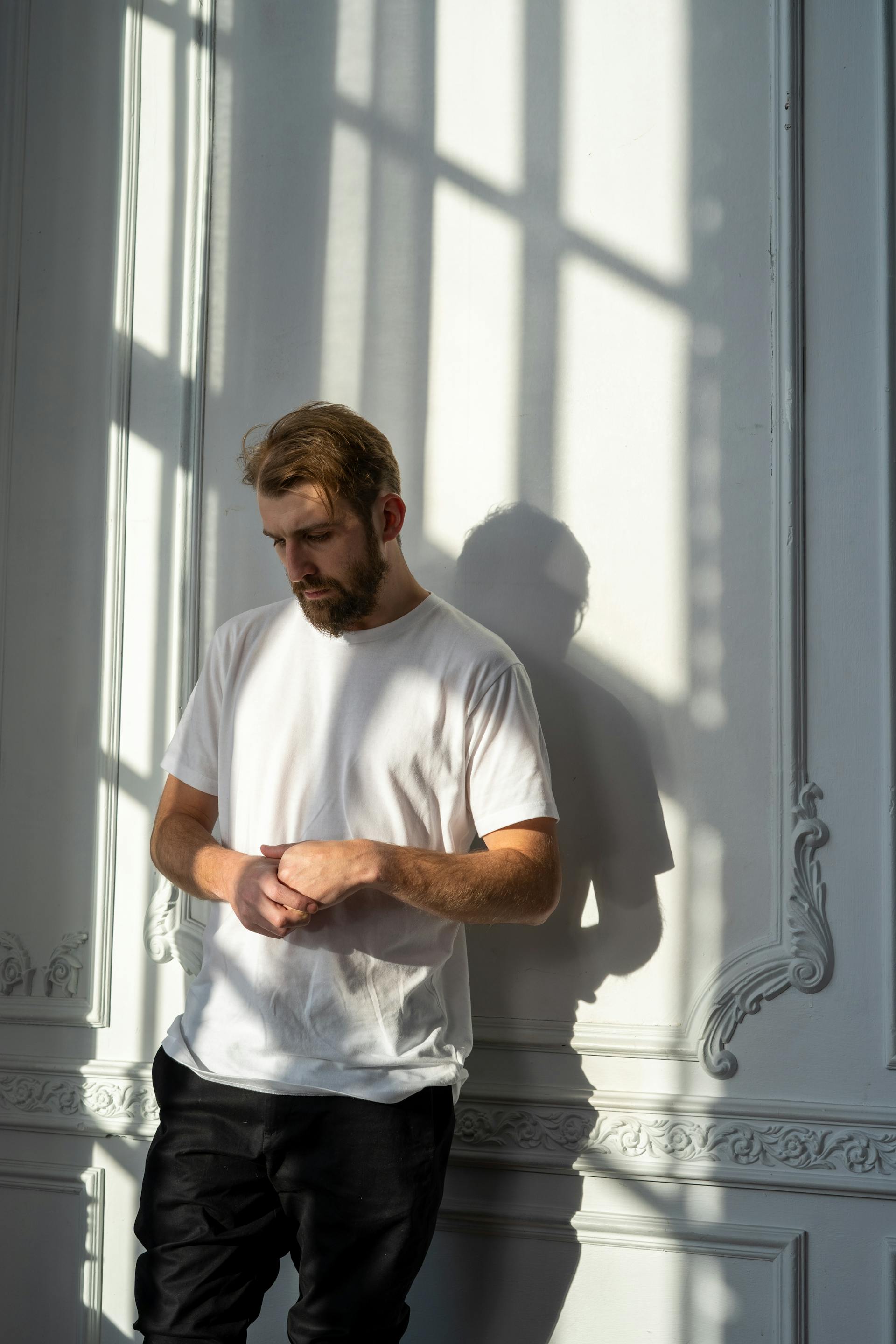 Un hombre preocupado apoyado en una pared | Fuente: Pexels