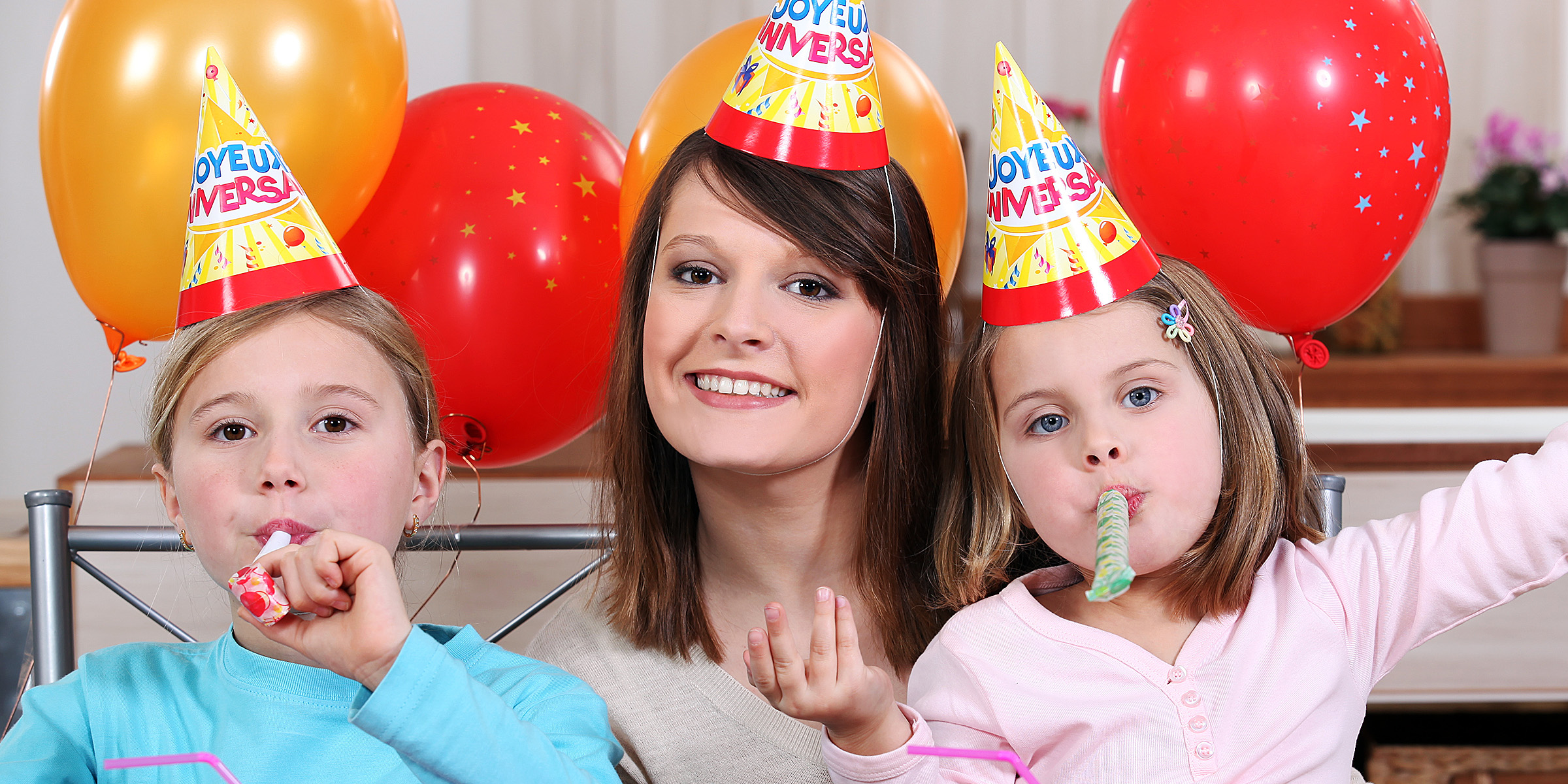 Una mujer con dos niños en una fiesta de cumpleaños | Fuente: Shutterstock