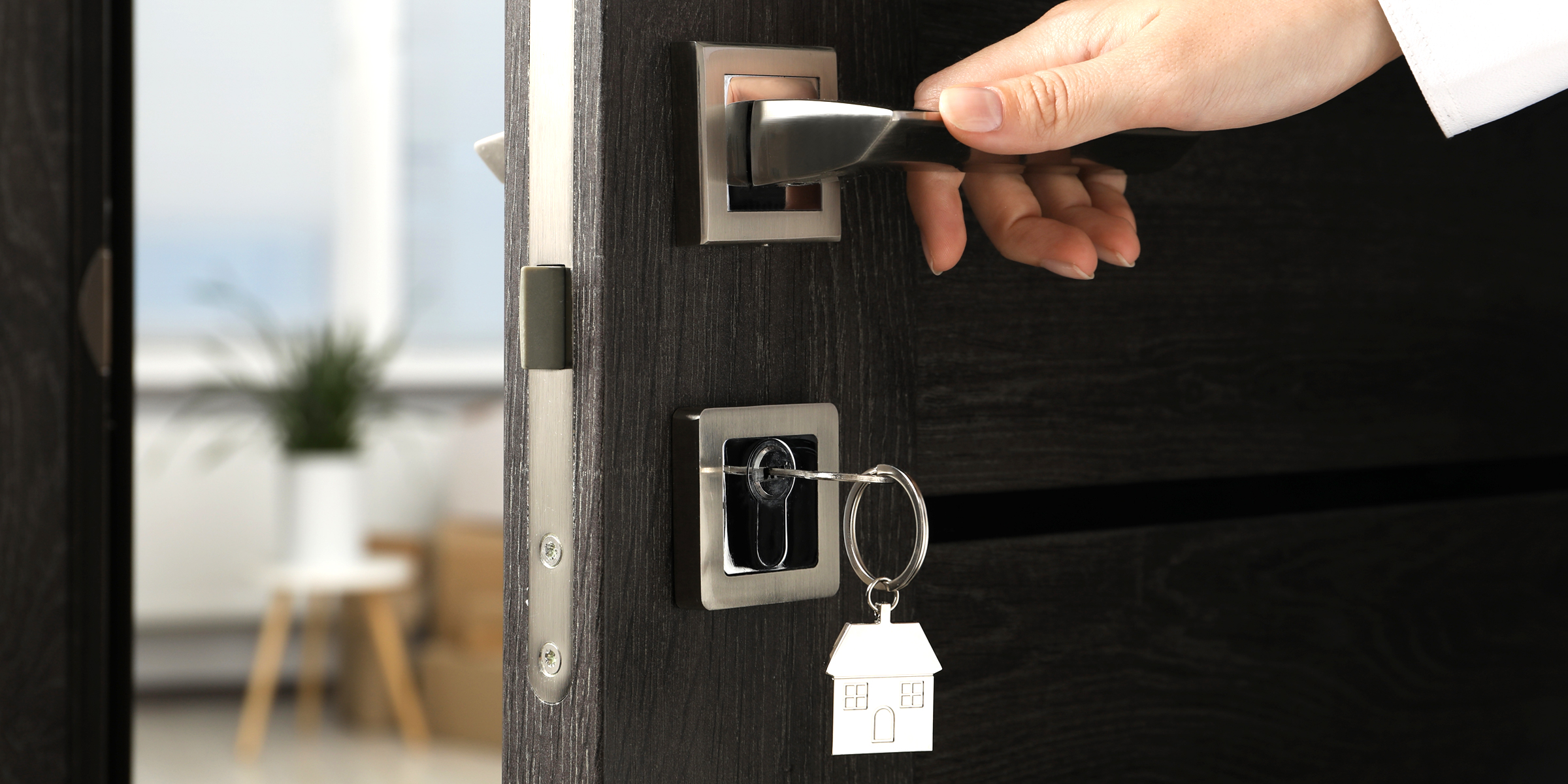 Una mujer abriendo una puerta de entrada | Fuente: Shutterstock