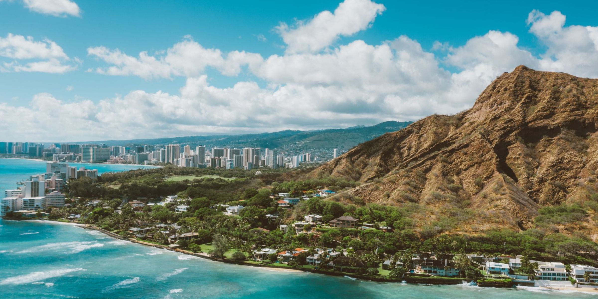 Coastal city beside a rugged mountain and turquoise ocean | Source: Pexels