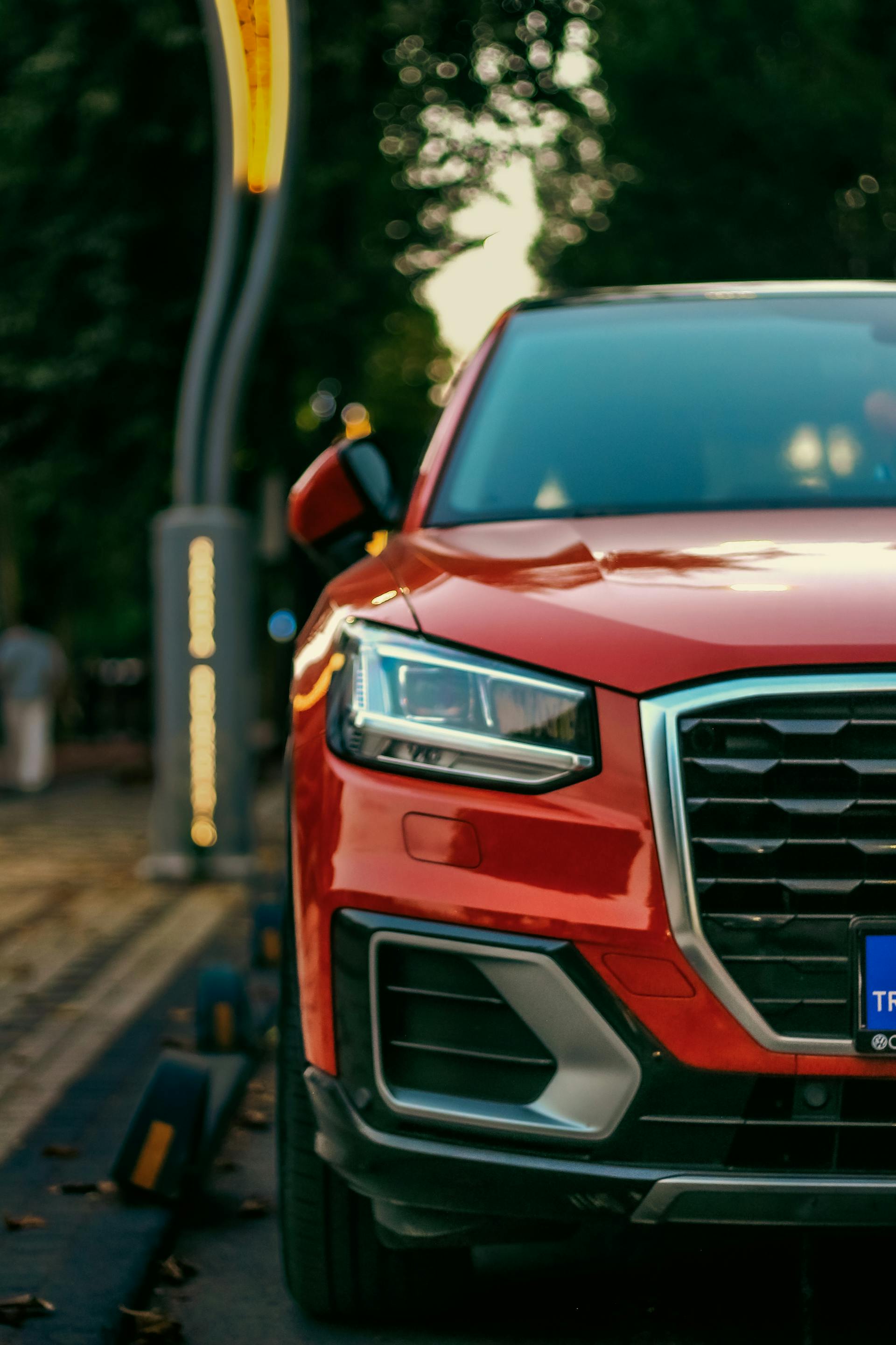 Primer plano de un todoterreno rojo aparcado a un lado de la carretera | Fuente: Pexels