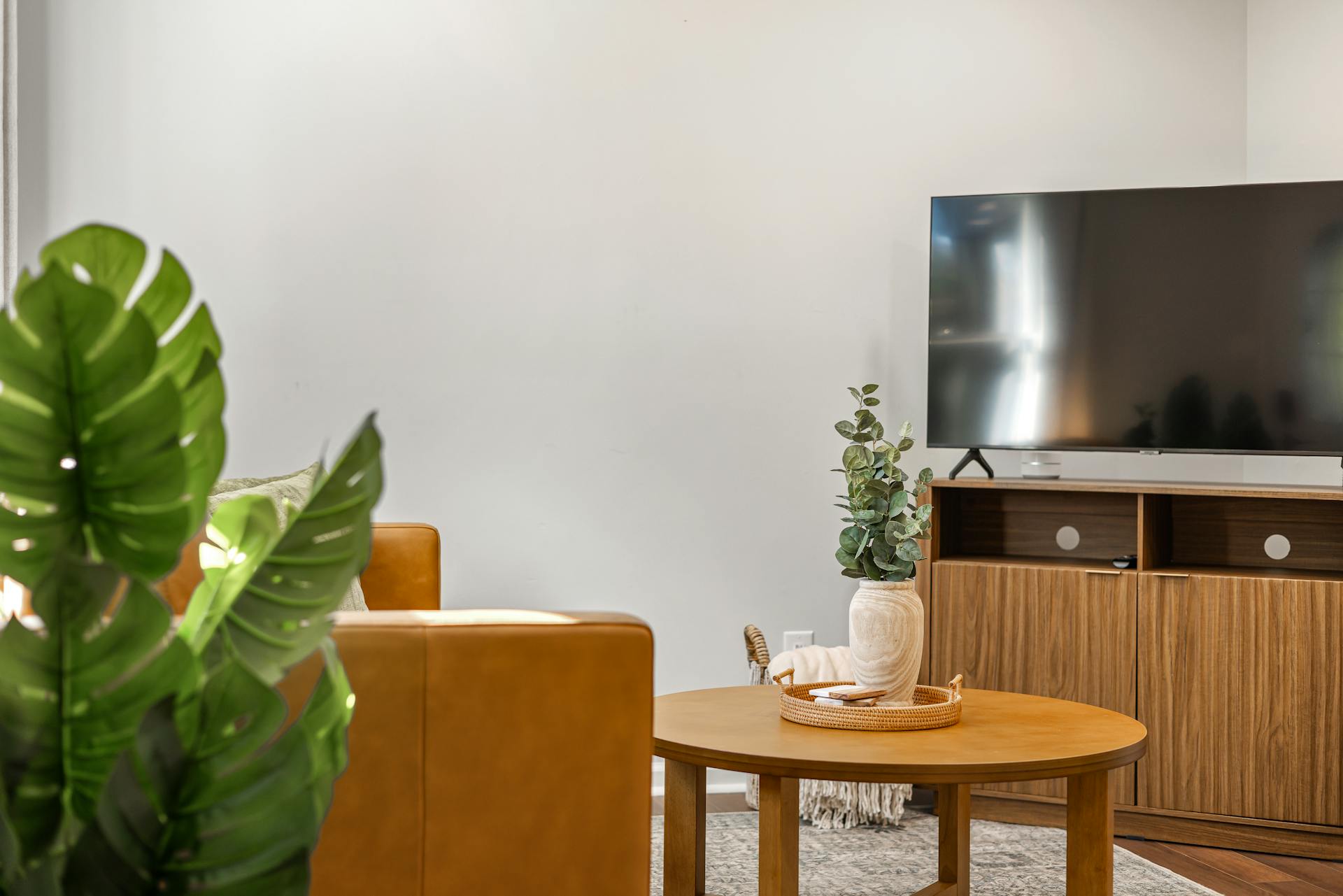 Un televisor plano sobre una estantería de madera en una habitación | Fuente: Pexels