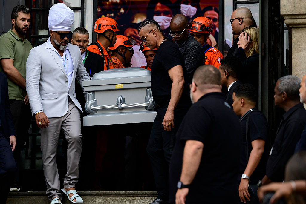 El músico brasileño Carlinhos Brown (izq.) carga el féretro de la cantante y actriz Preta Gil, tras el velorio en el Theatro Municipal de Río de Janeiro, Brasil, el 25 de julio de 2025. | Getty Images