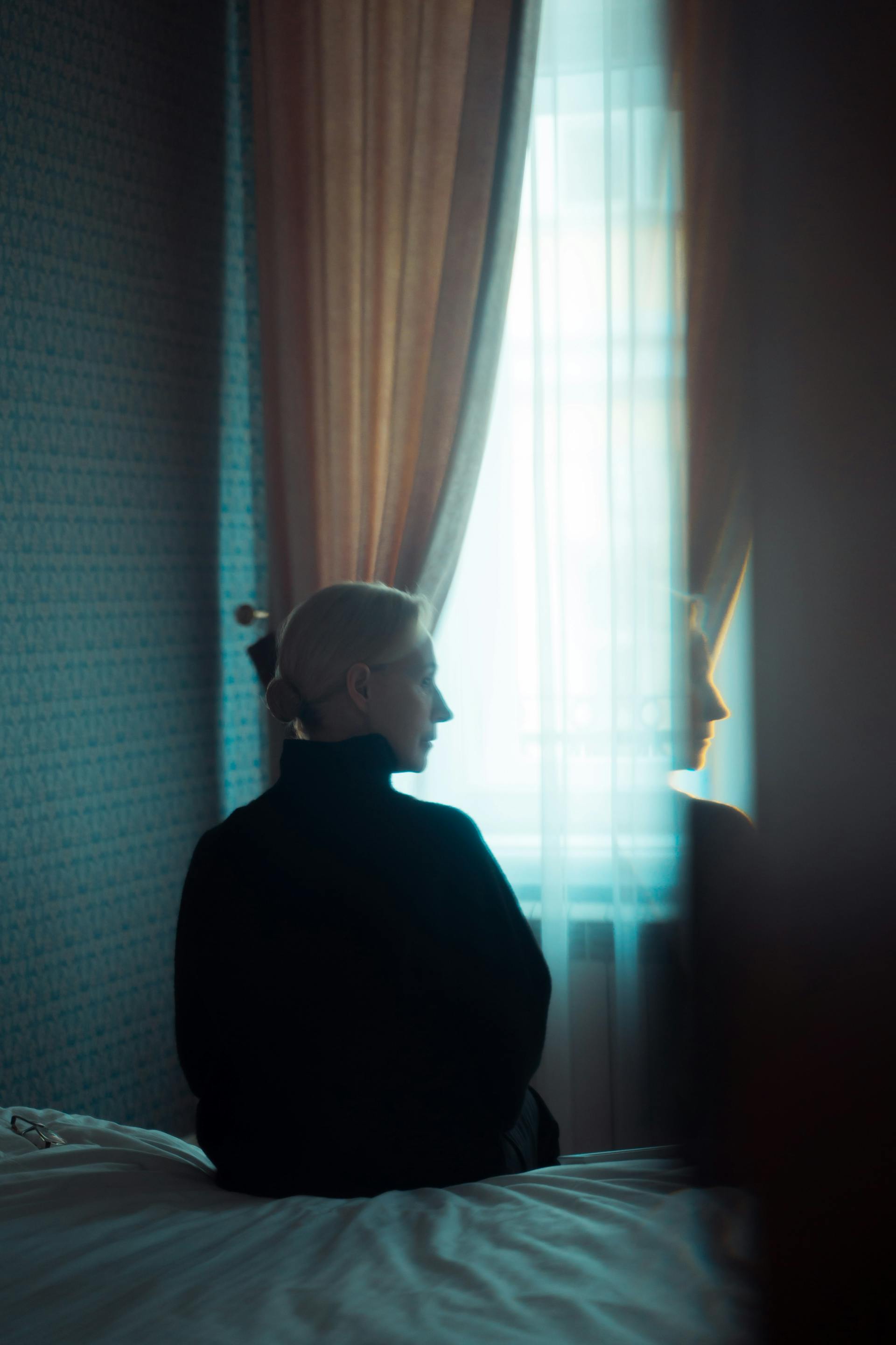 Una mujer sentada en su habitación | Fuente: Pexels