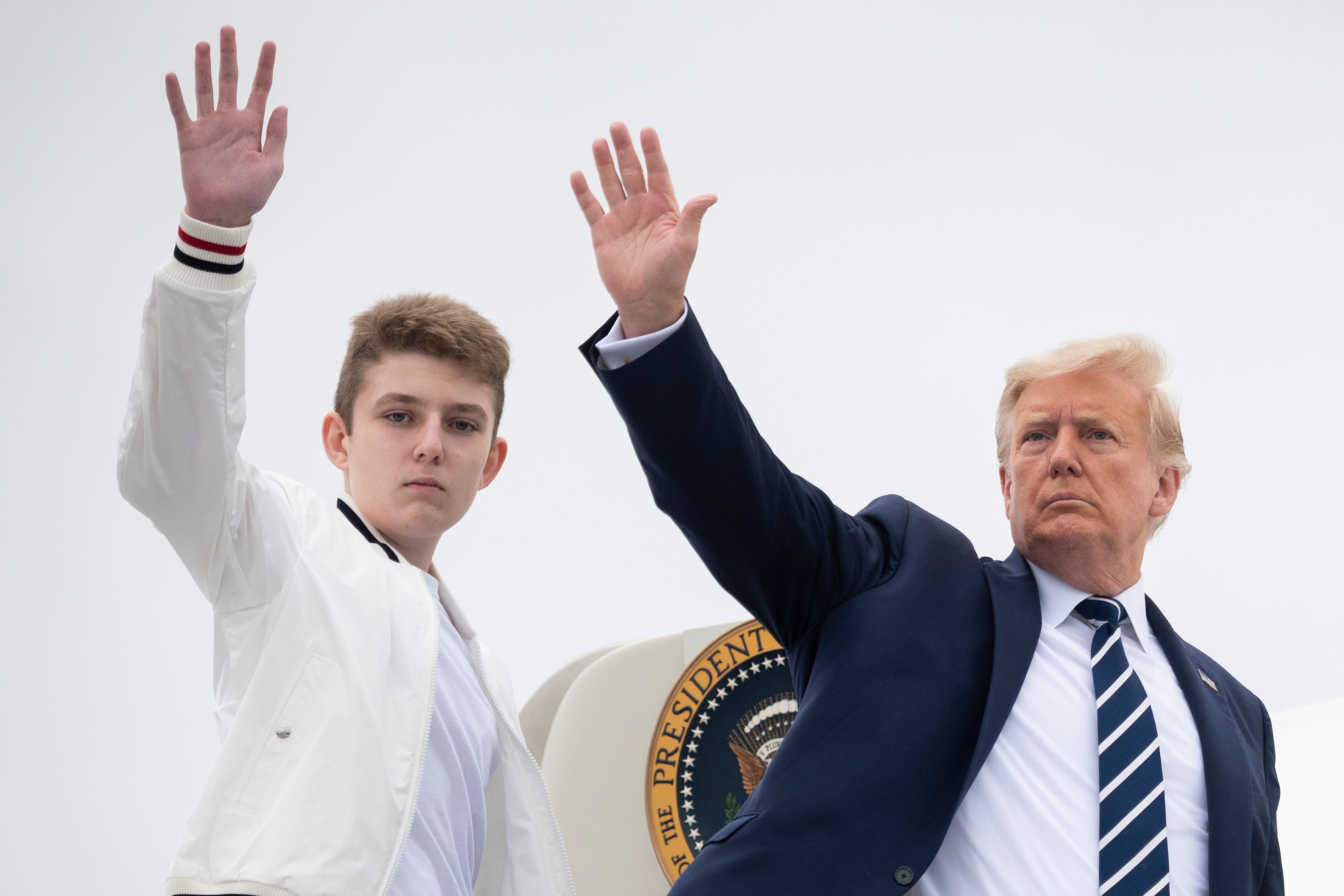 Donald Trump y su hijo Barron saludan mientras suben al Air Force One en el Aeropuerto Municipal de Morristown, Nueva Jersey, el 16 de agosto de 2020 | Fuente: Getty Images
