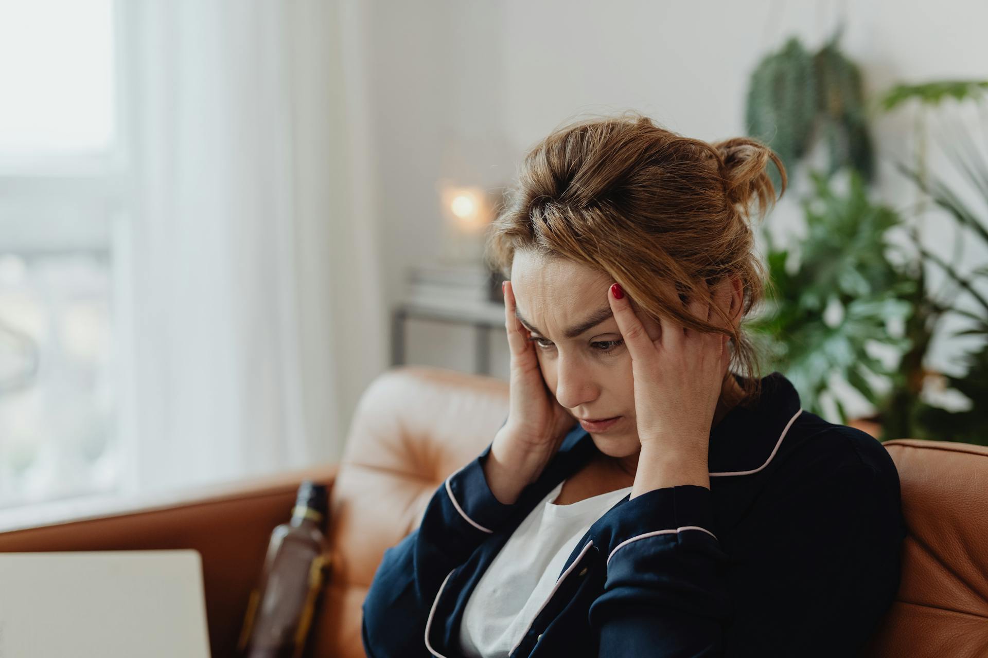 Una mujer ansiosa sentada en el sofá | Fuente: Pexels