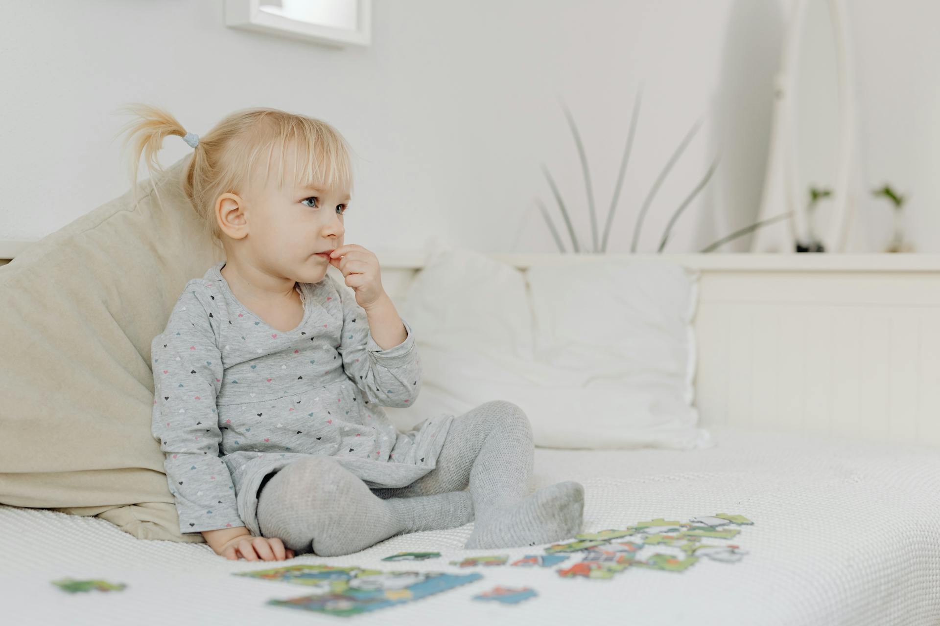 Una niña sentada sola mientras juega con un puzzle | Fuente: Pexels