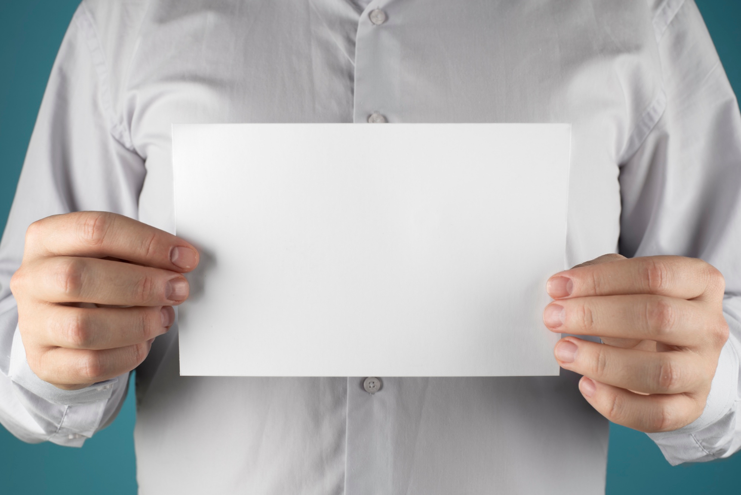 Un hombre sujetando una hoja de papel | Fuente: Freepik
