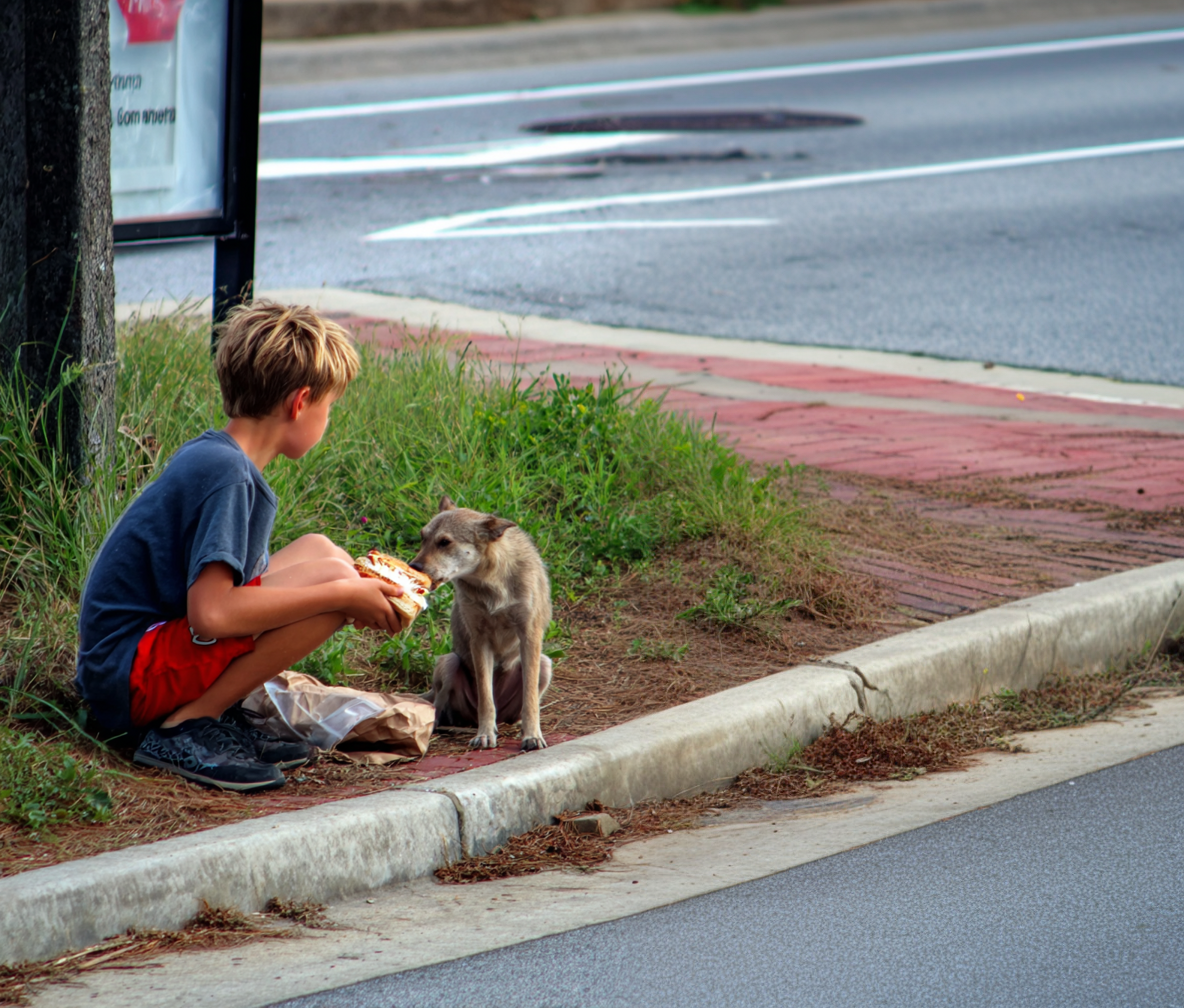 Un niño dando de comer a un perro | Fuente: Midjourney
