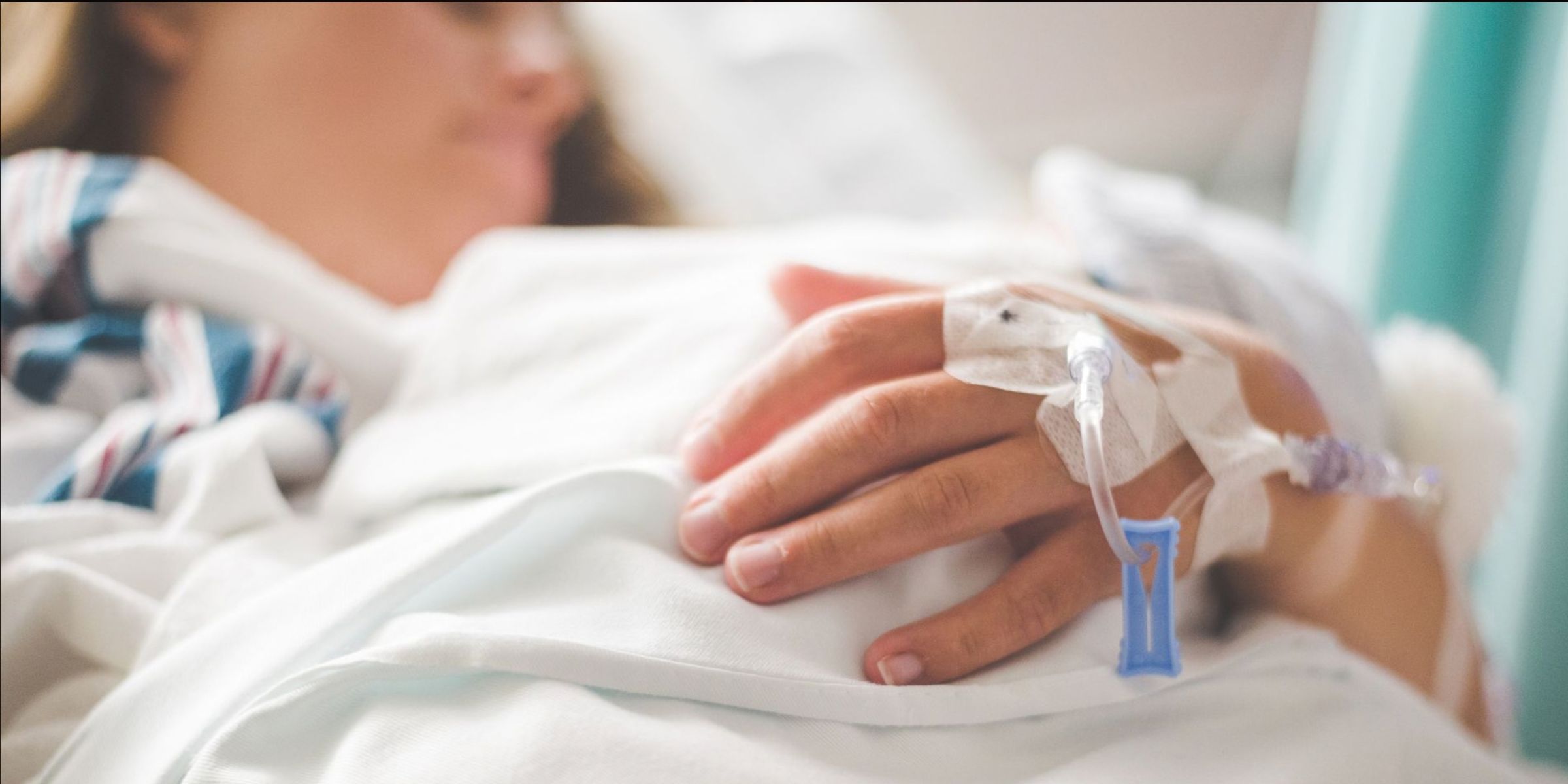 A focused shot of a patient's arm with an intravenous tube in a hospital setting | Source: Pexels