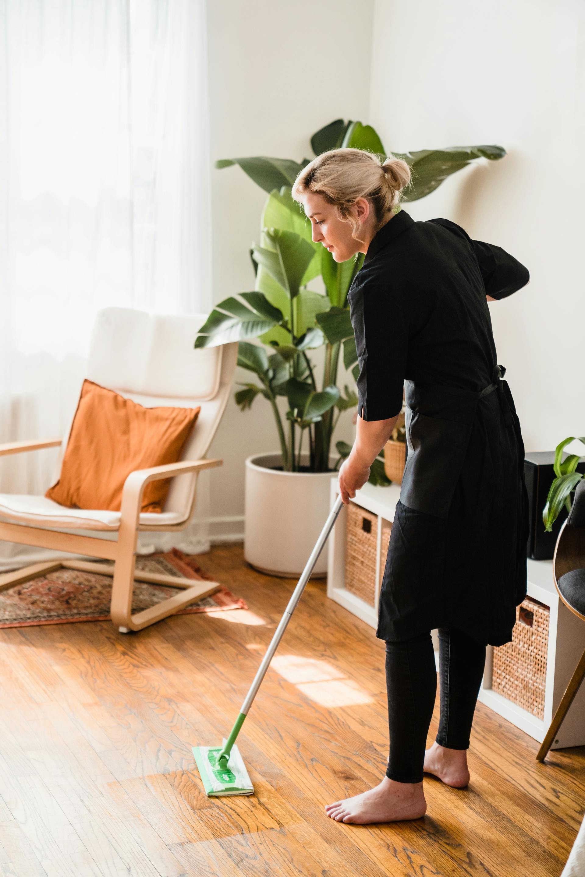 Una mujer barriendo el suelo | Fuente: Pexels