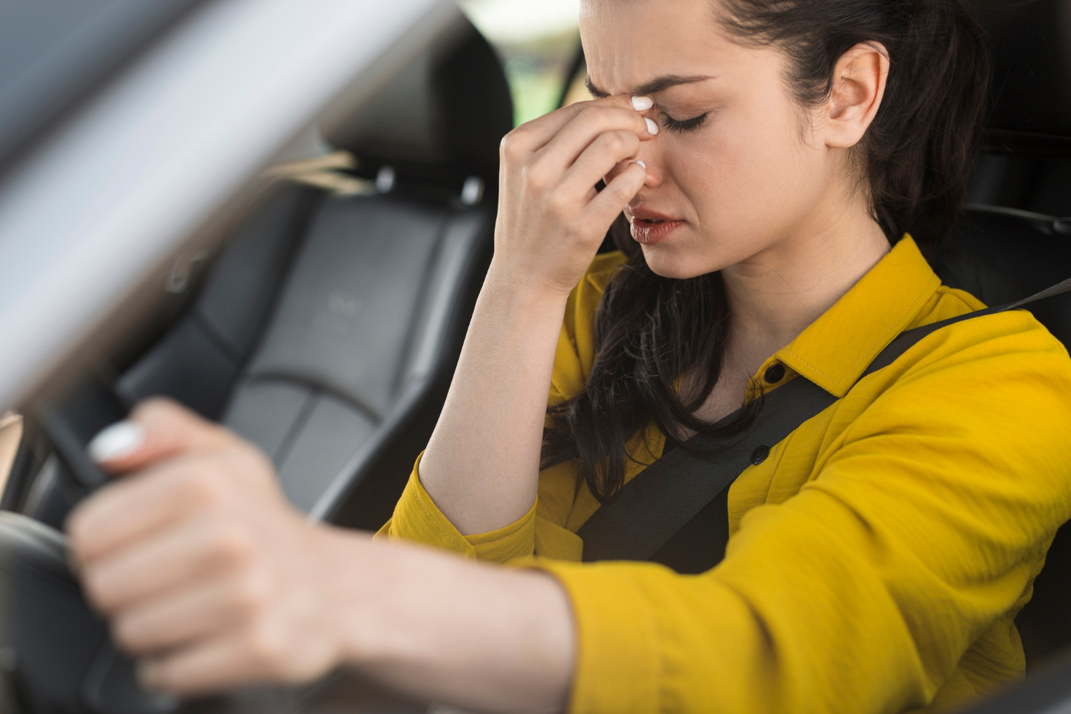 Una mujer tensa sentada al volante de su vehículo | Fuente: Freepik