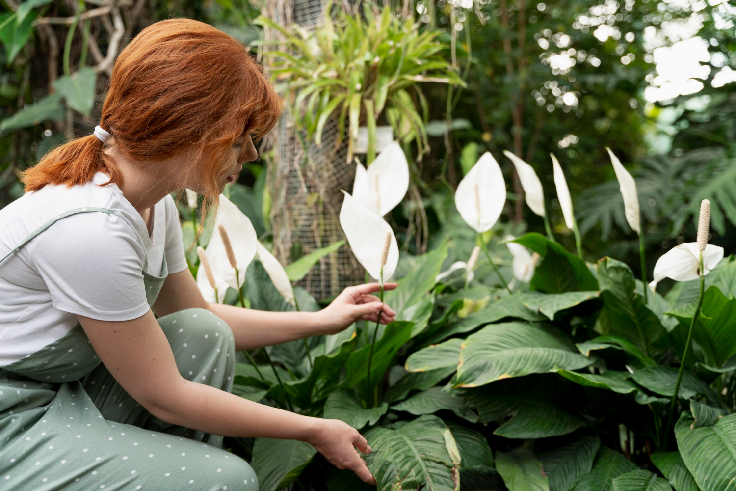 Una joven cuidando las plantas de un jardín | Fuente: Freepik