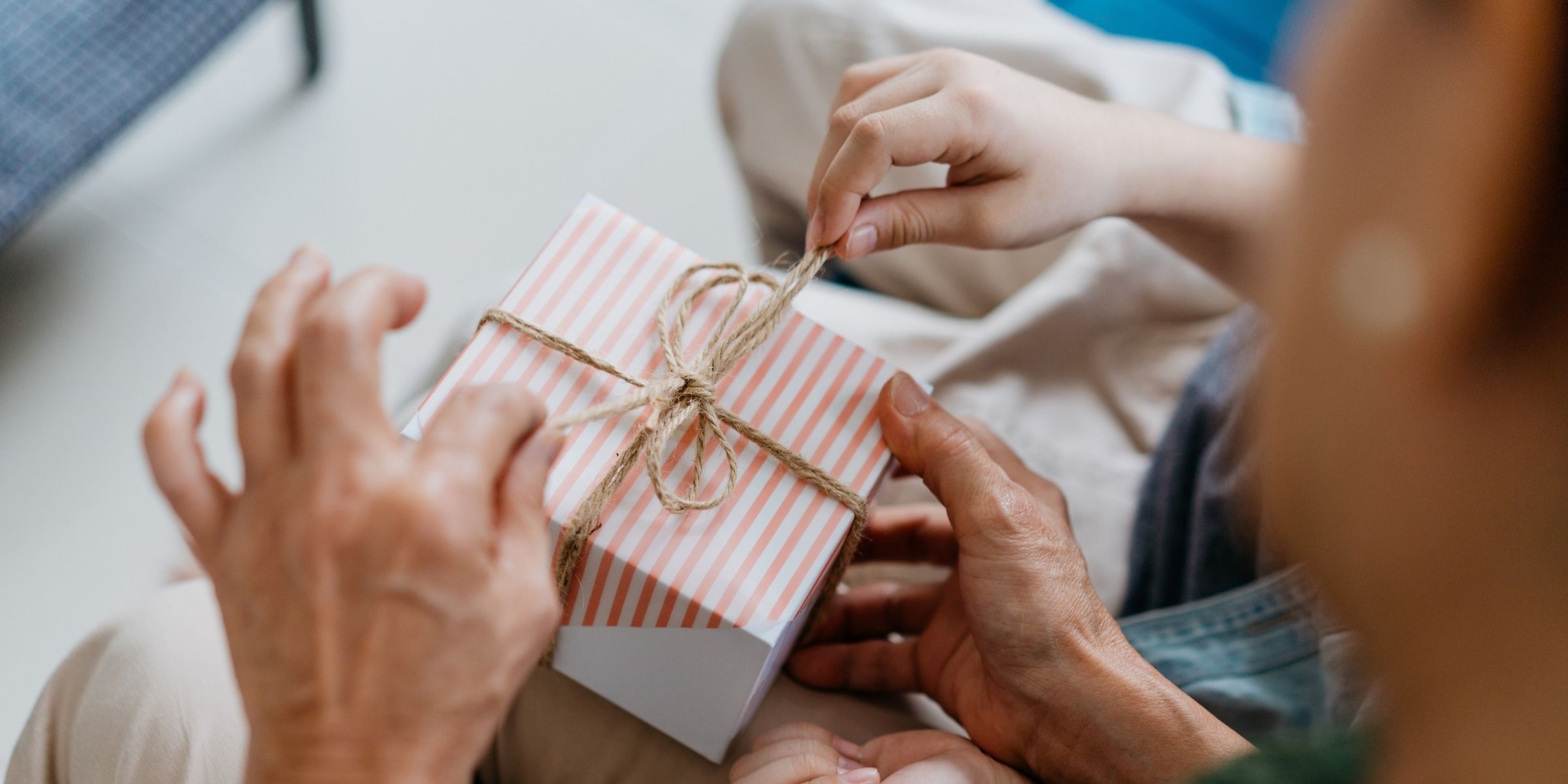 A grandmother and grandchild opening a gift box | Source: Getty Images
