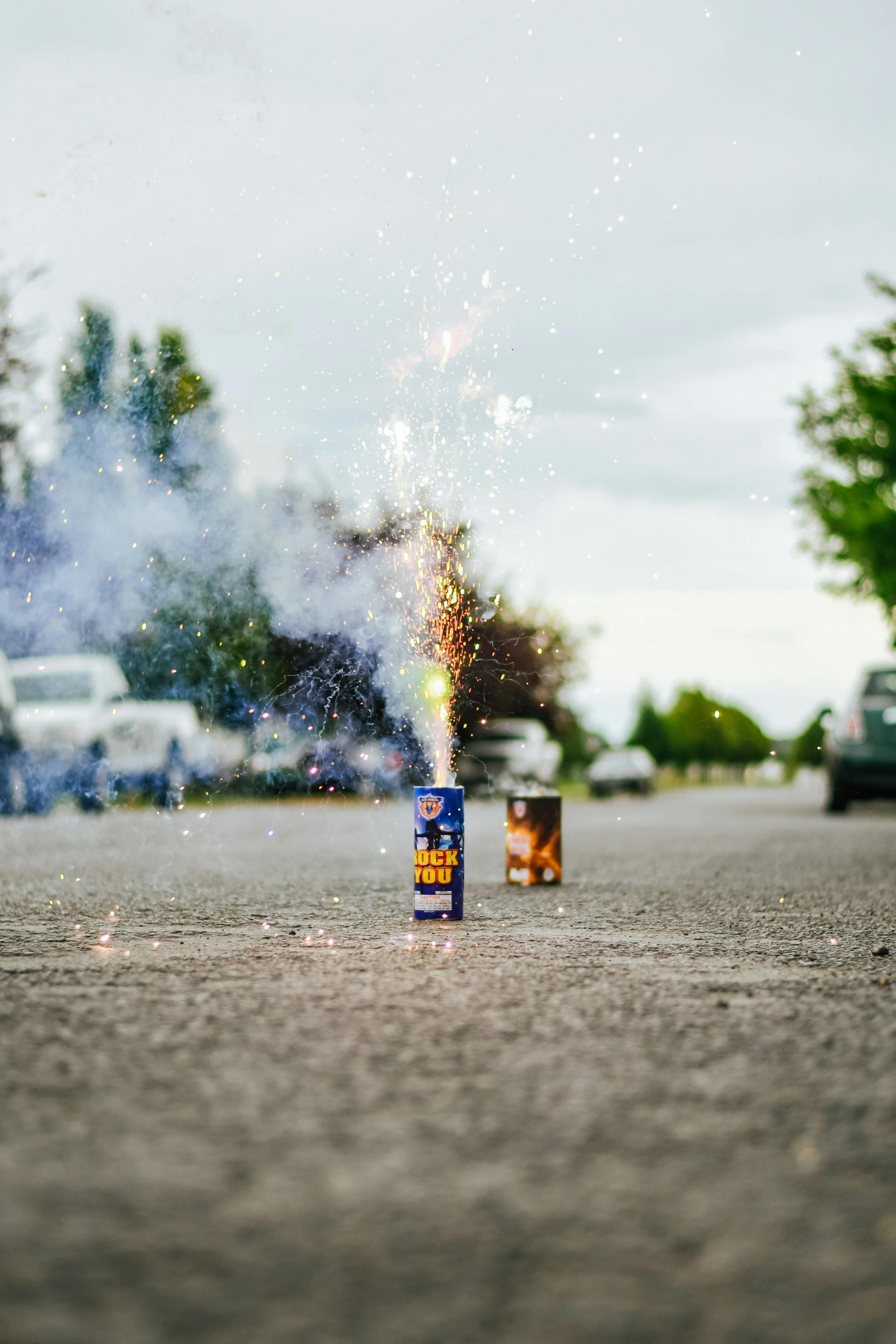 Fuegos artificiales encendidos en una calle | Fuente: Pexels