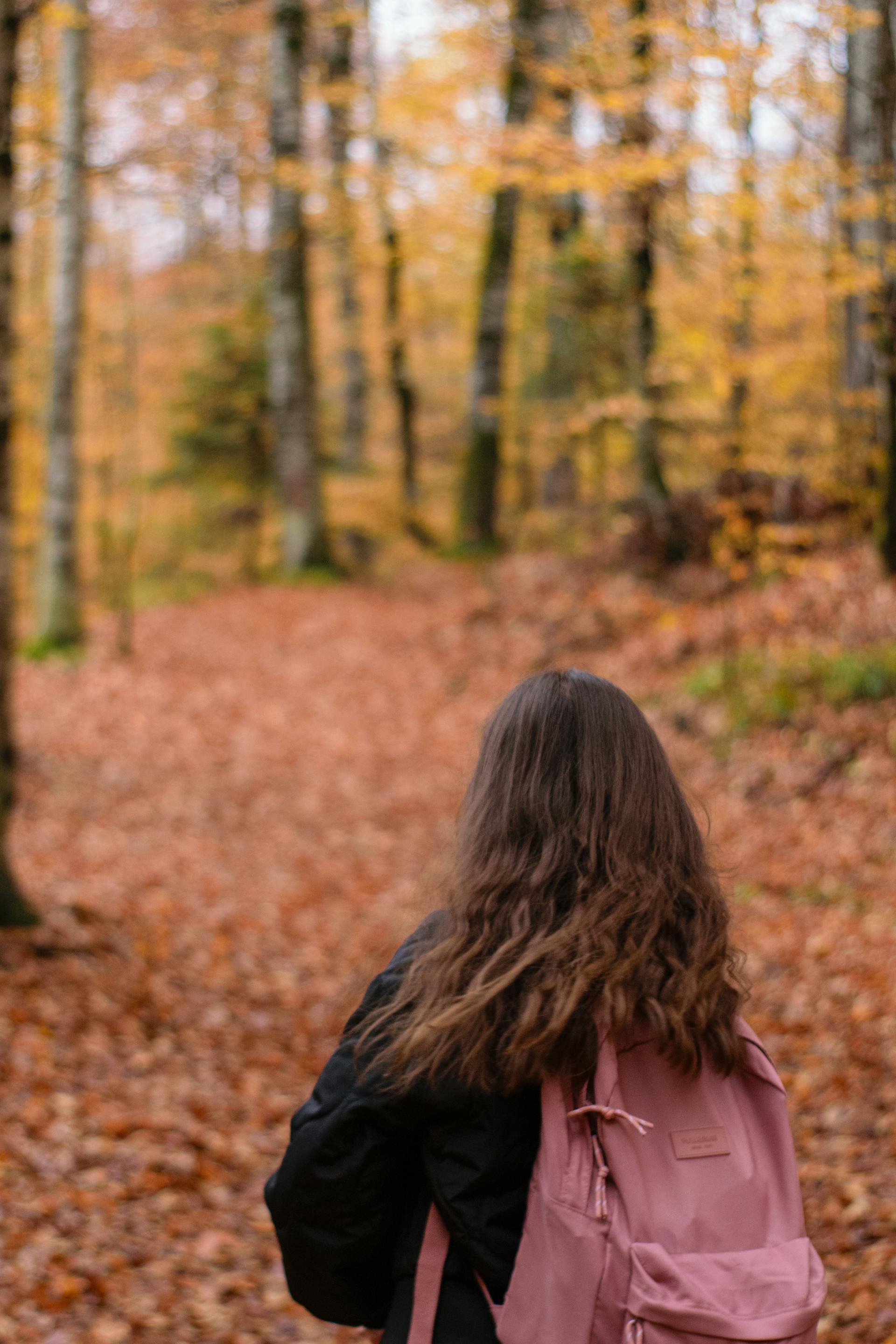 Una mujer de pie en un parque durante la estación otoñal | Fuente: Pexels