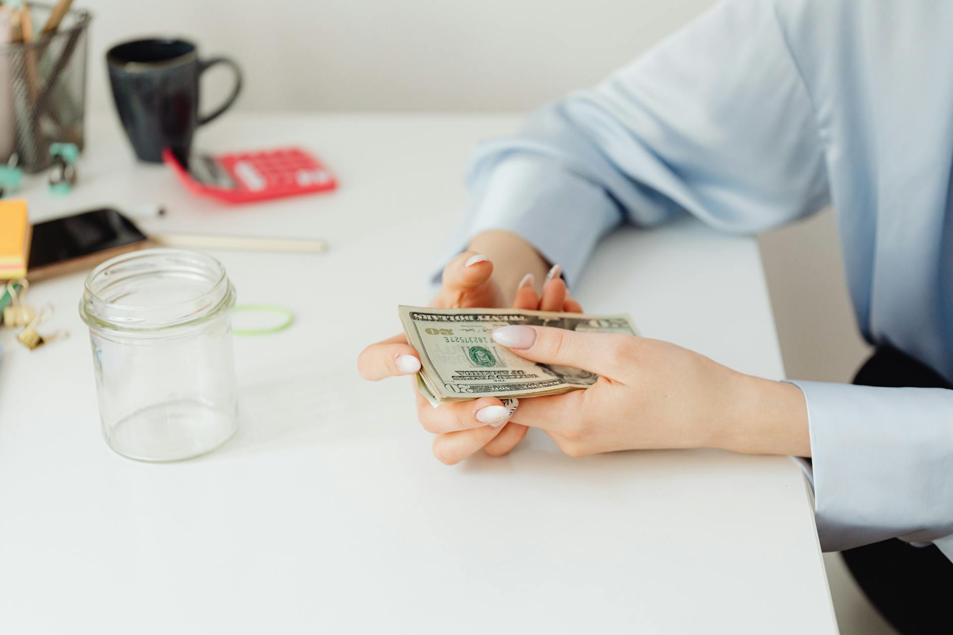 Una mujer con dinero en la mano | Fuente: Pexels
