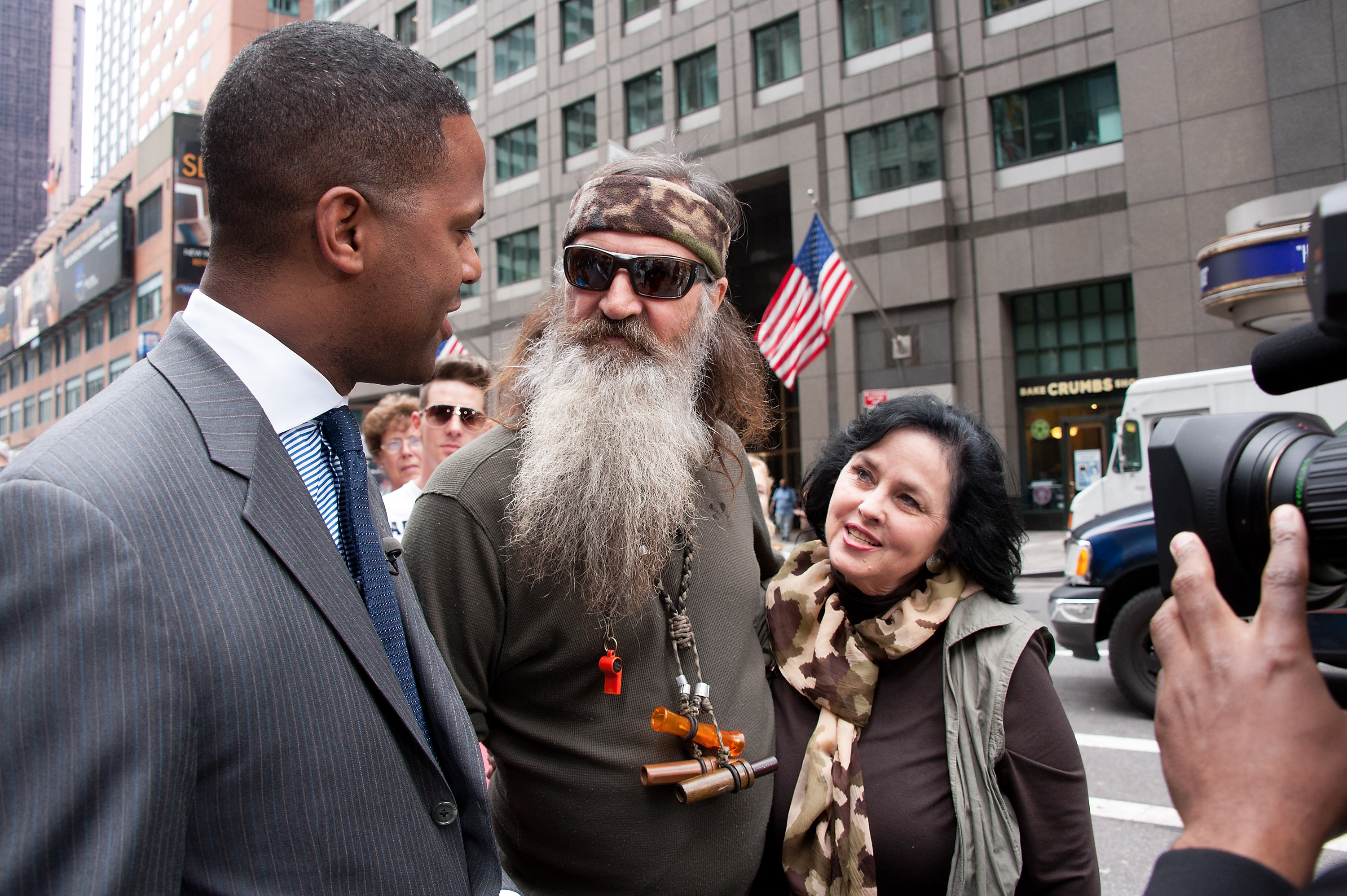 AJ Calloway entrevista a Phil y Kay Robertson durante su visita a "Extra" en Times Square el 7 de mayo de 2013, en la ciudad de Nueva York. | Fuente: Getty Images