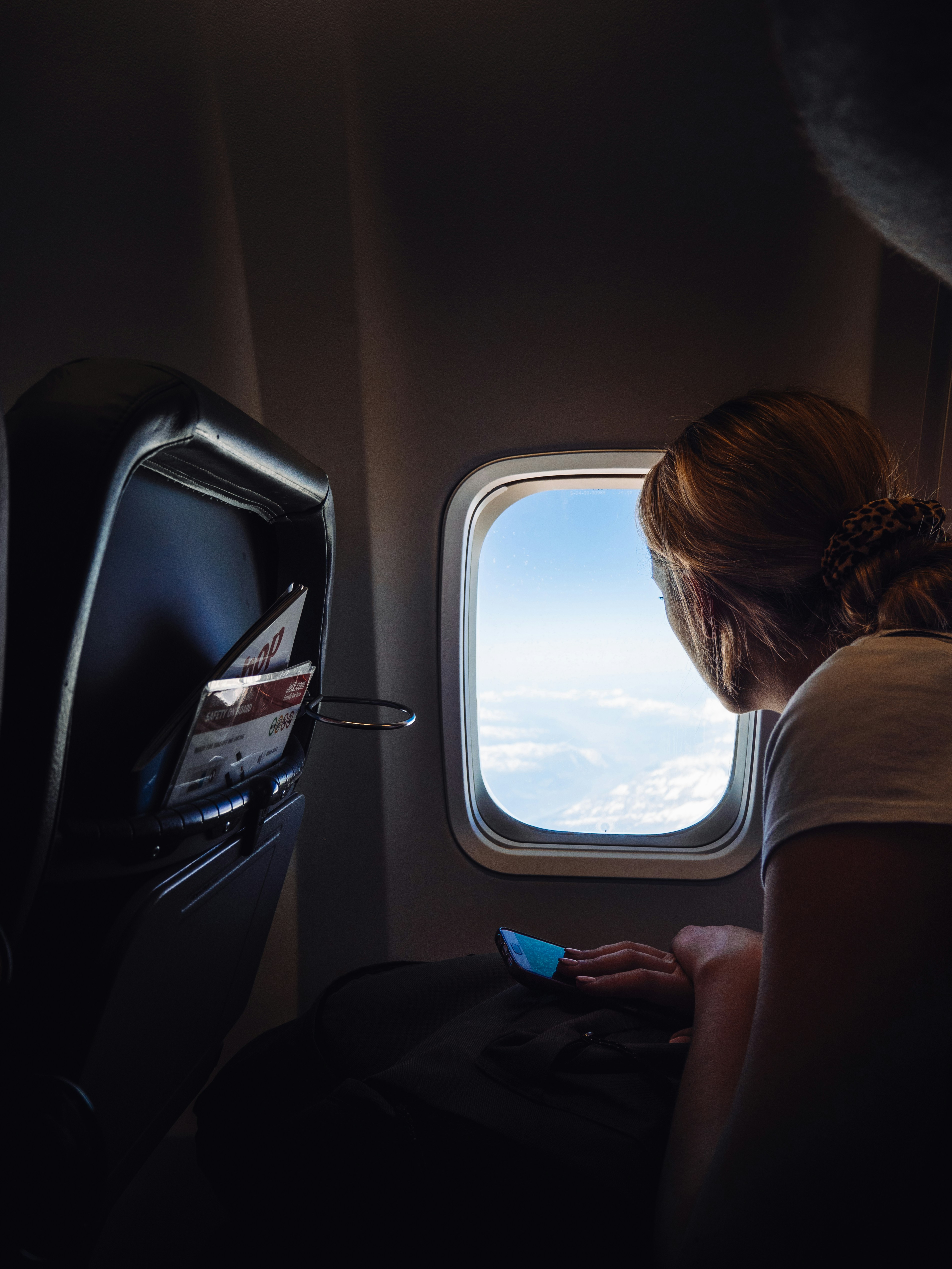 Una mujer sentada en un avión y mirando al exterior | Fuente: Unsplash