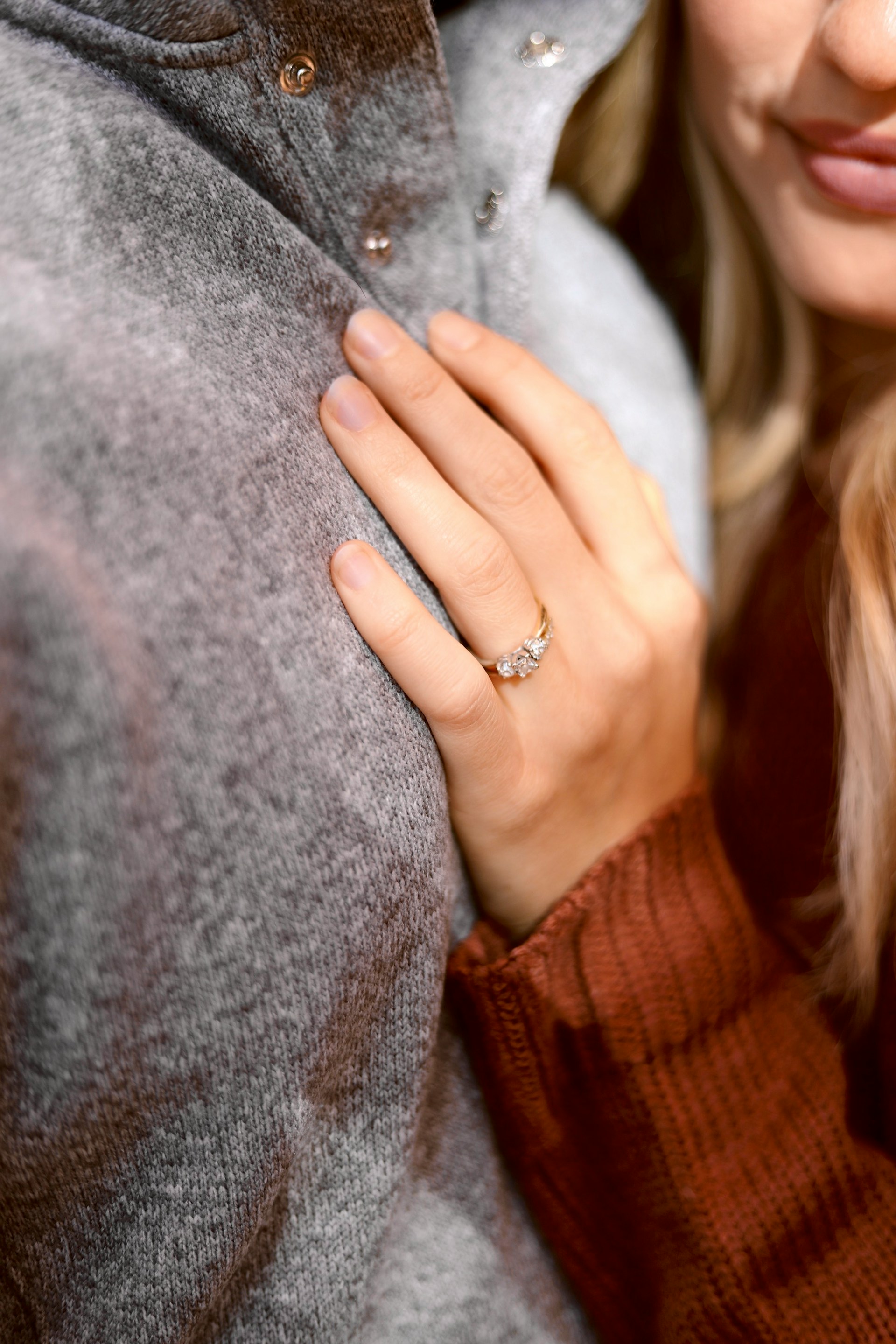 Una mujer abrazando a su pareja mientras presume de su anillo de compromiso | Fuente: Unsplash