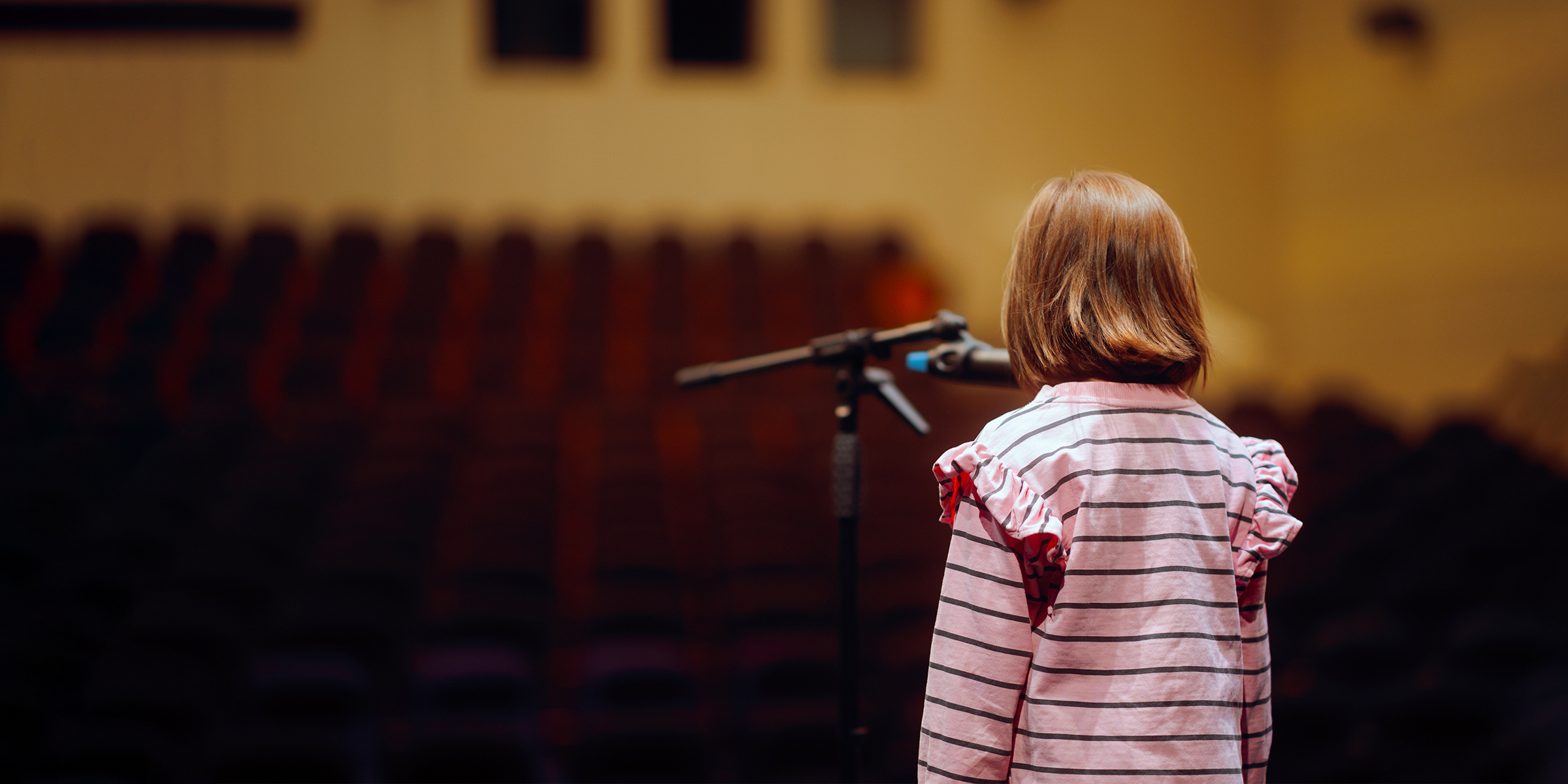 Una chica delante de un micrófono | Fuente: Shutterstock