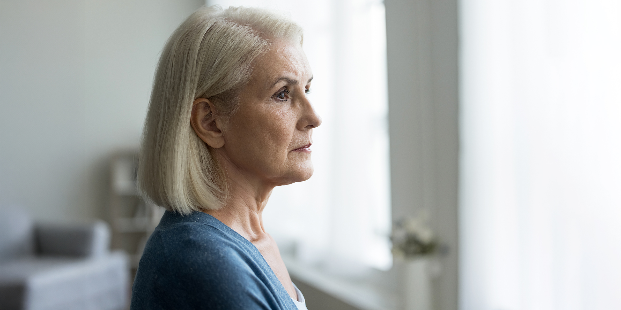 Una mujer tensa mirando por la ventana | Fuente: Shutterstock