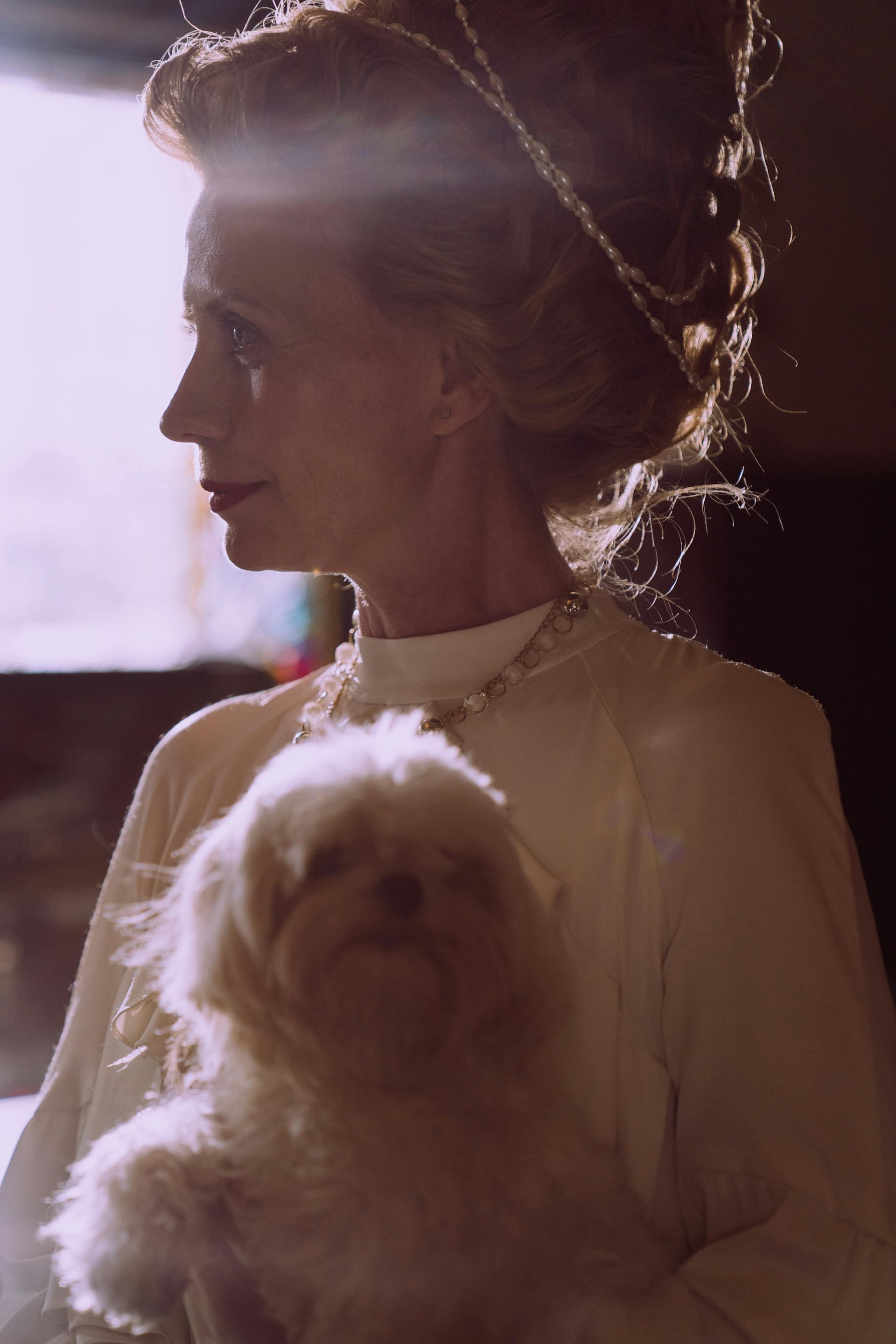 Una mujer de mediana edad con un perro en brazos | Fuente: Pexels