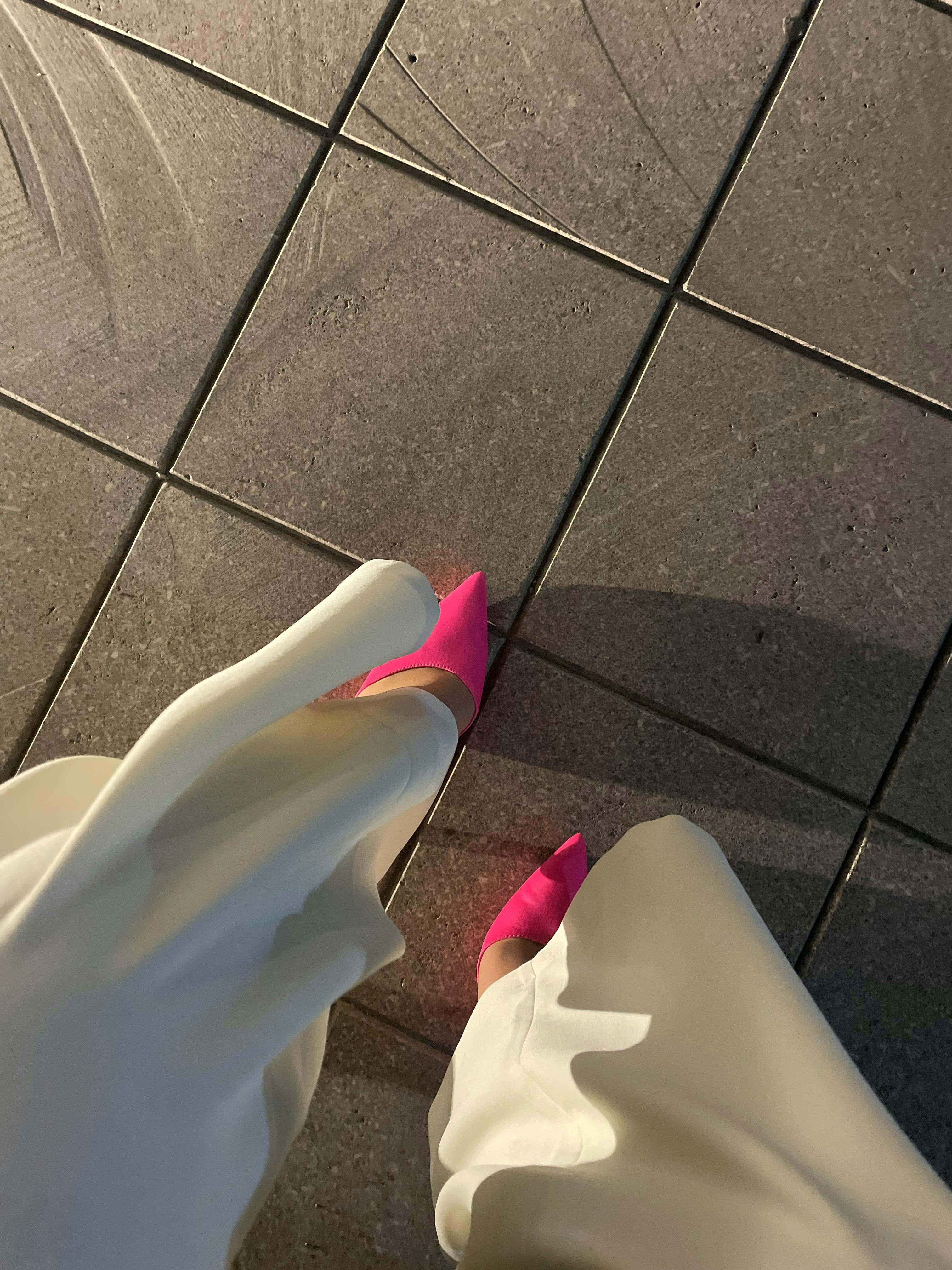 Pantalones blancos y zapatos rosas de mujer | Fuente: Pexels