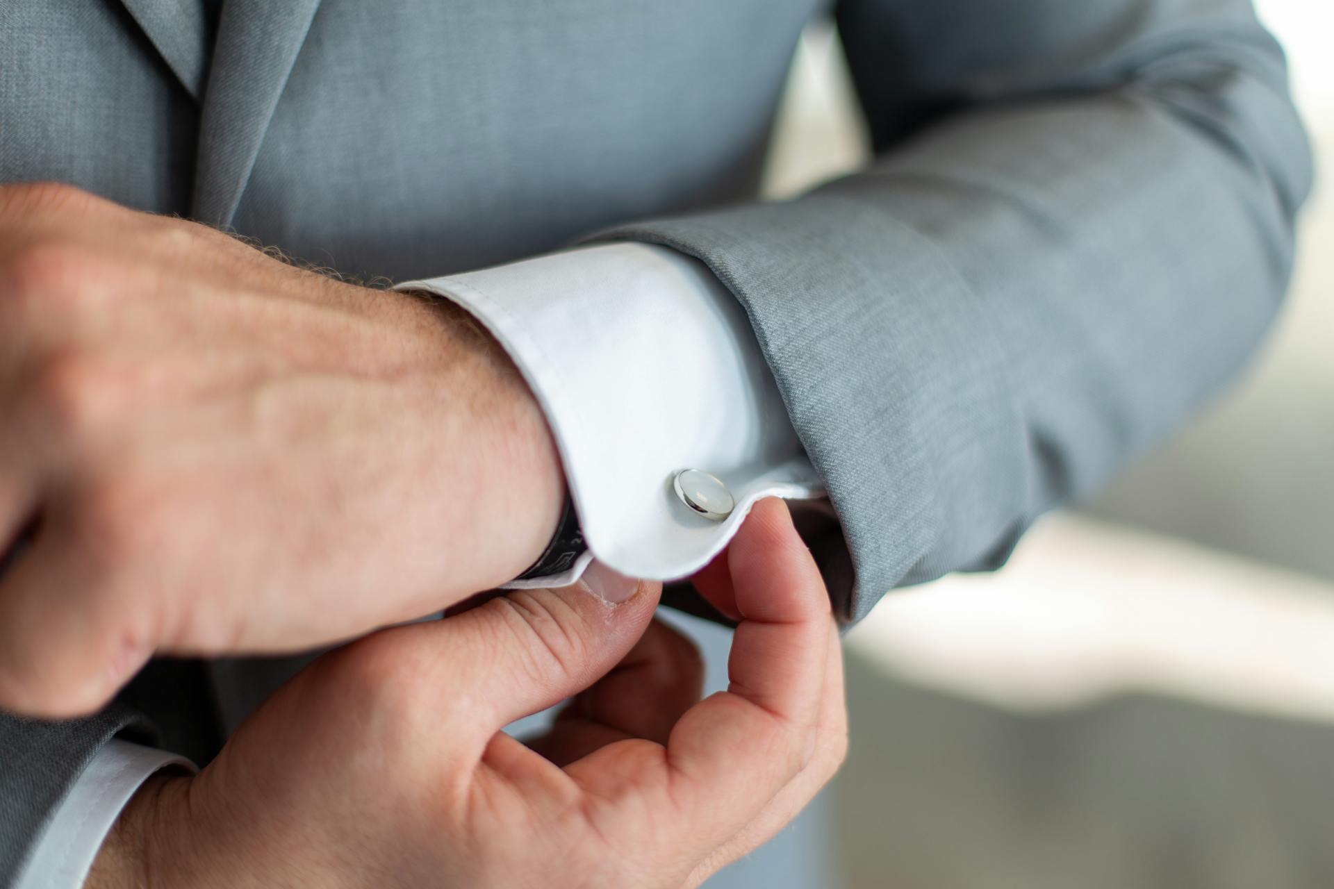 Un hombre ajustándose el gemelo | Fuente: Pexels