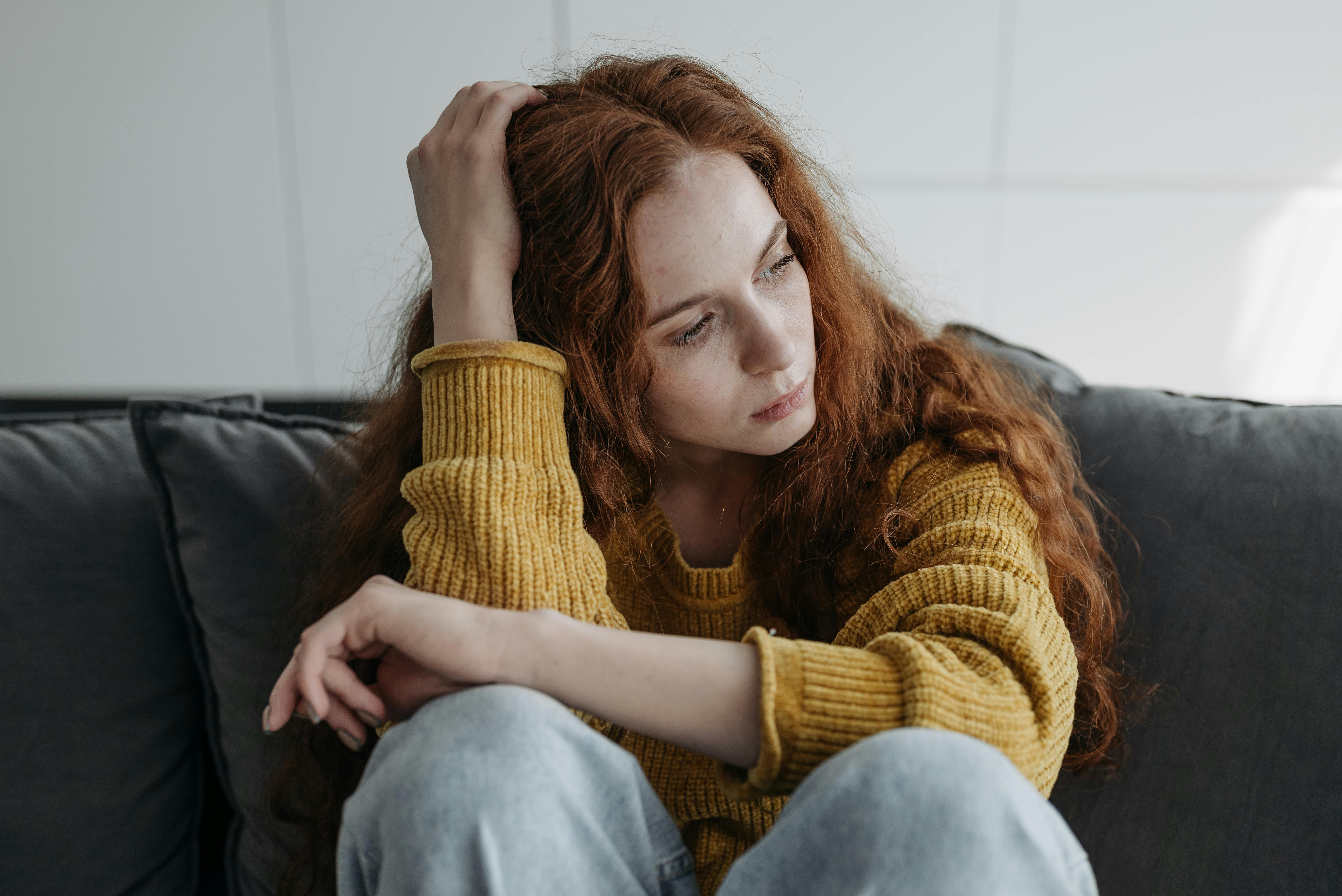 Una mujer sentada en un sofá | Fuente: Pexels