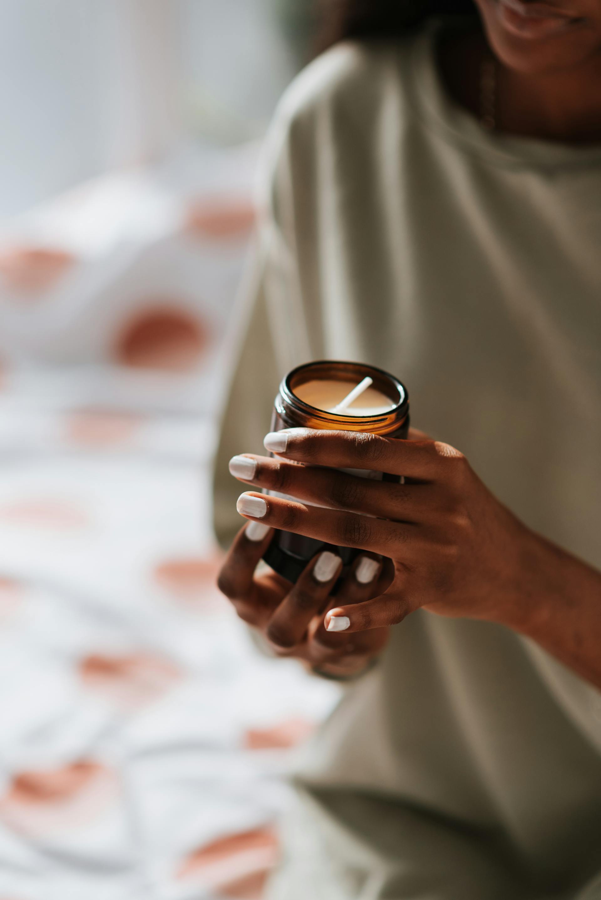 Una mujer sosteniendo una vela perfumada | Fuente: Pexels