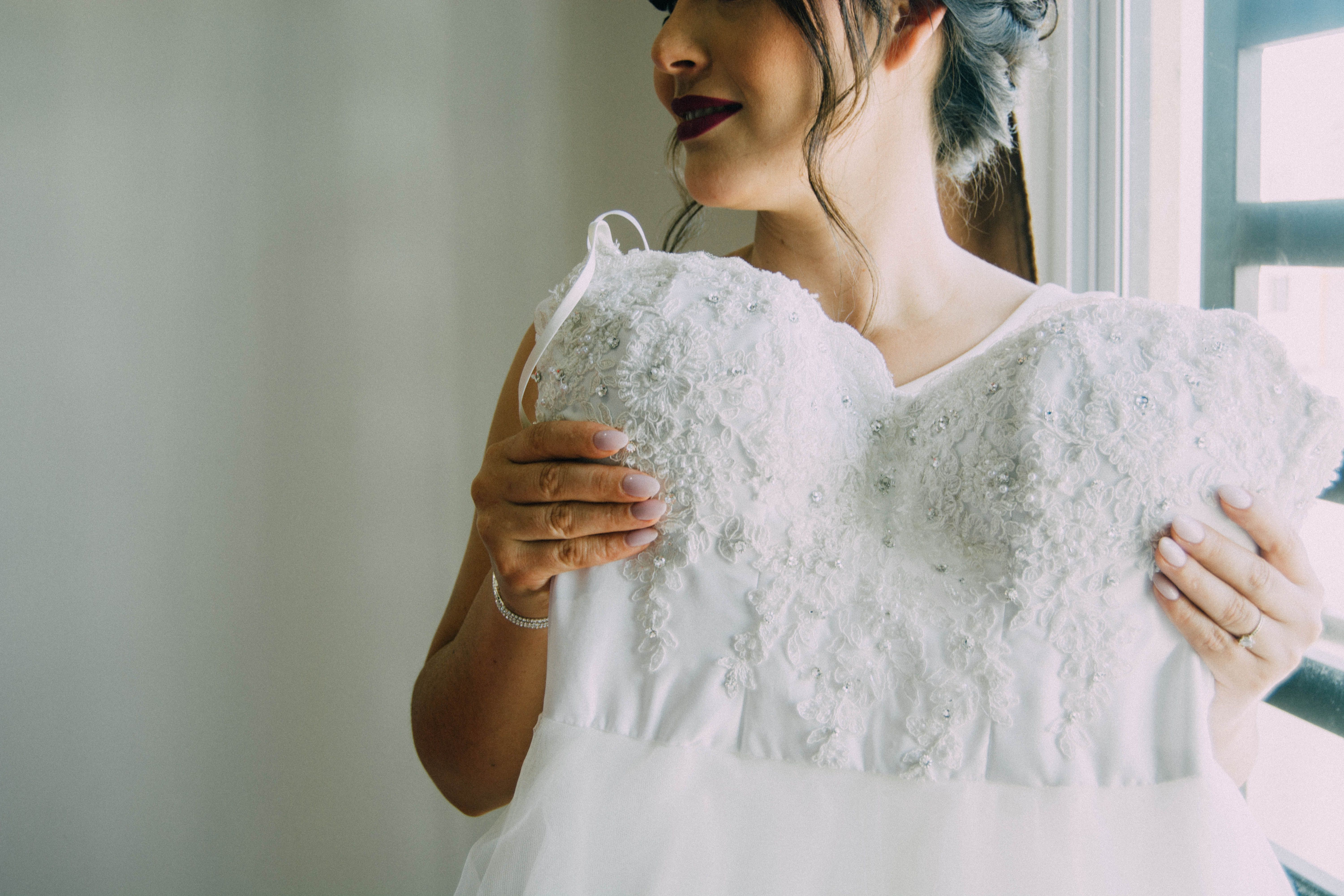 A woman holding her wedding dress | Source: Pexels