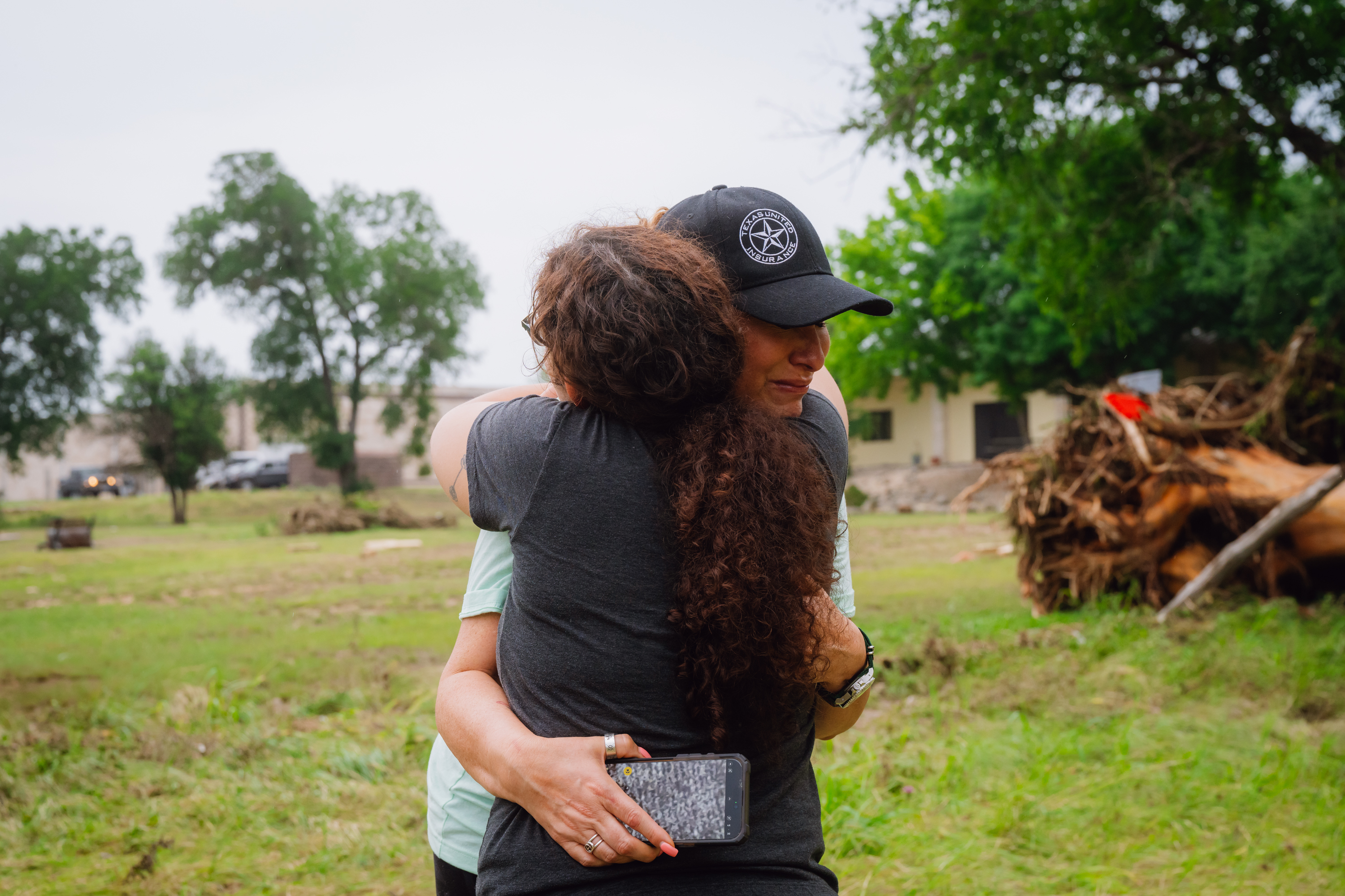 Lisa Christina Aguillen (derecha) se emociona después de que los agentes del orden recuperaran un cuerpo cerca del río Guadalupe en el condado de Kerrville, Texas, el domingo 6 de julio de 2025. | Fuente: Getty Images.
