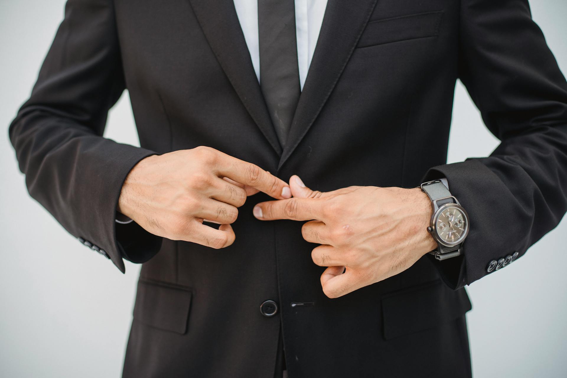 Primer plano de un hombre con traje negro | Fuente: Pexels